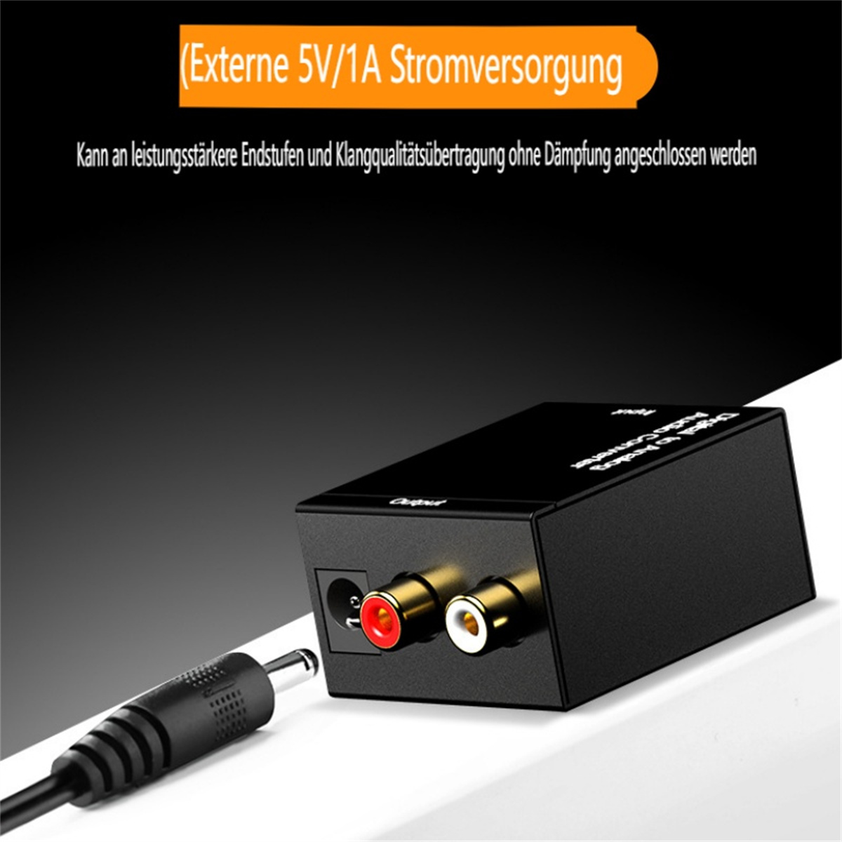 Ein schwarzer Audio-Konverter mit roten und weißen Eingangsanschlüssen, einem schwarzen Kabel und Text.