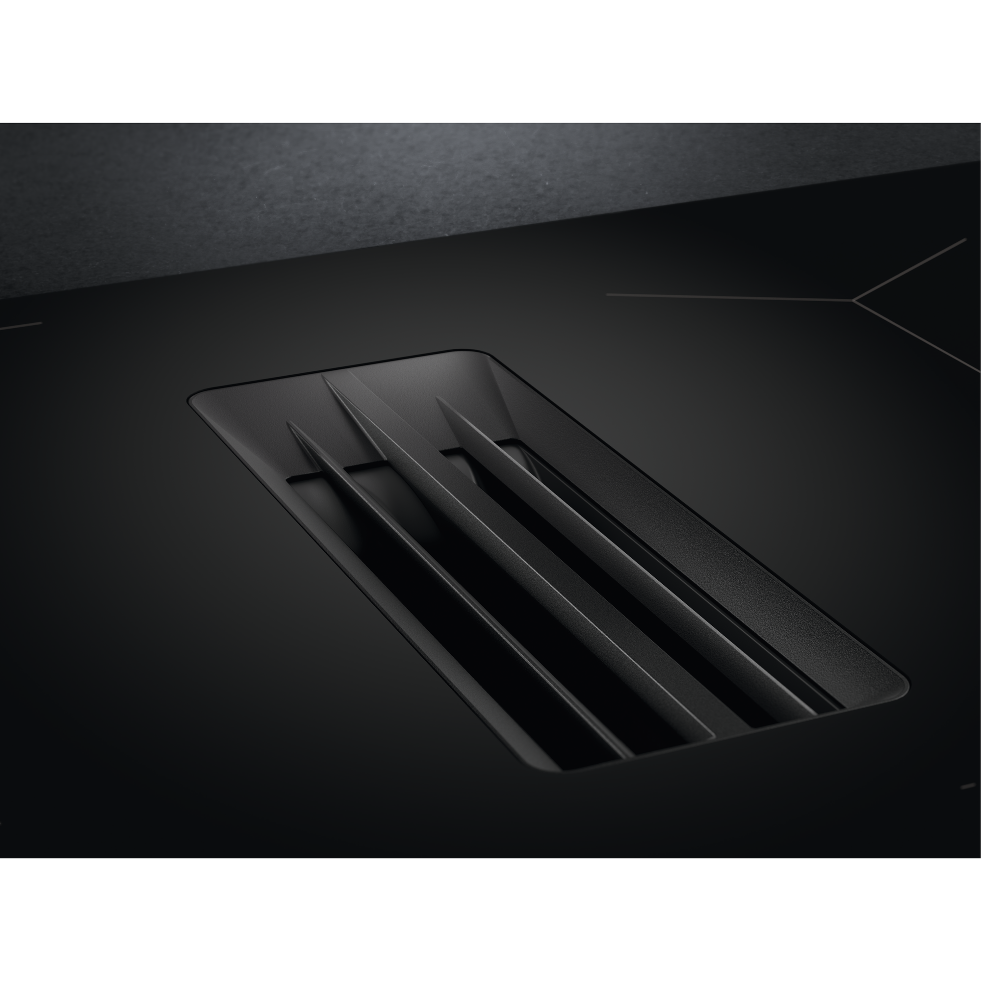 Primo piano di un piano cottura nero con ventola integrata.