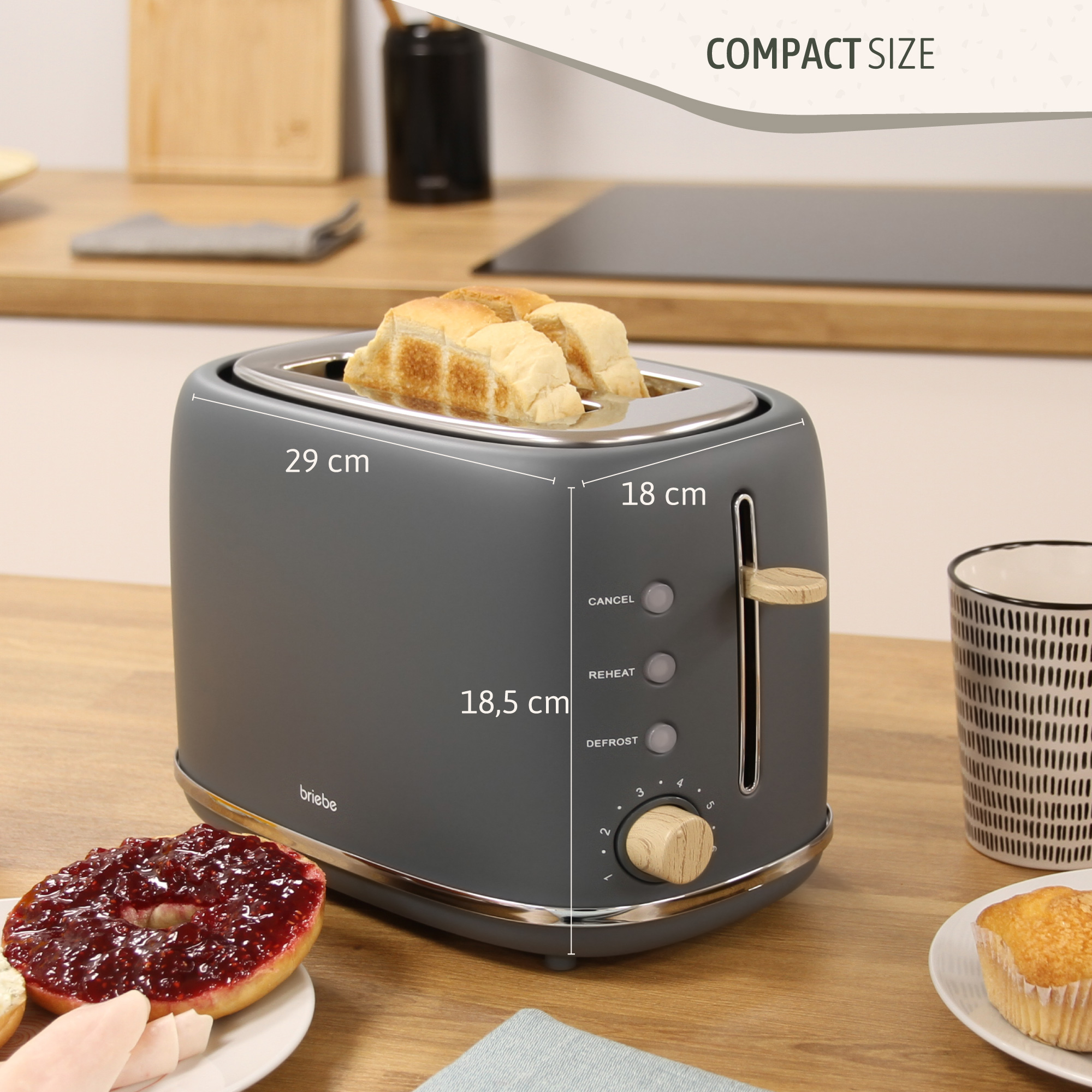 Grauer Toaster mit Brot. Abmessungen: 29 cm x 18 cm x 18,5 cm.