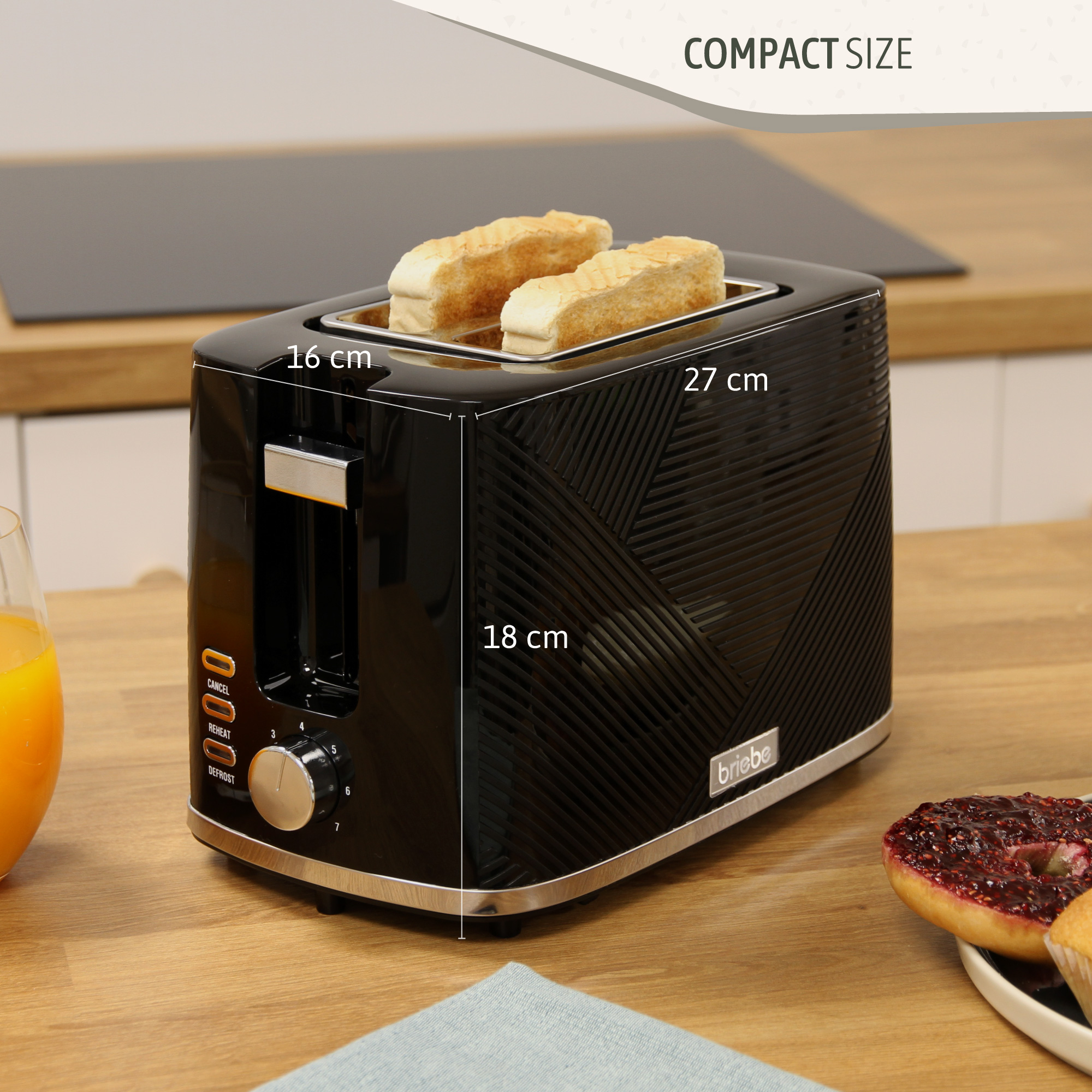 Ein schwarzer Toaster mit zwei Toastscheiben. Abmessungen: 16x18x27cm. Der Toaster steht auf einer Holzoberfläche.