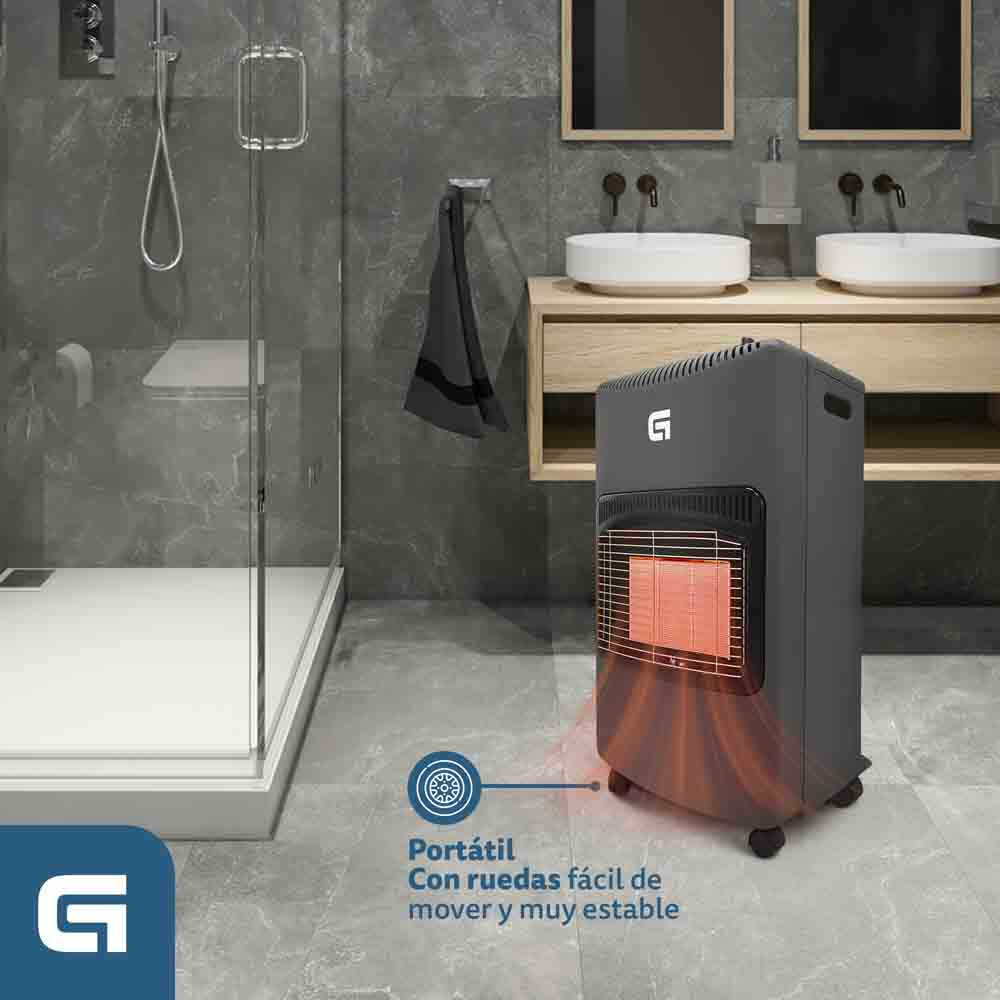 Un calefactor portátil gris con ruedas en un baño, cerca de una ducha. Tiene un elemento calefactor visible y el logotipo de la marca.