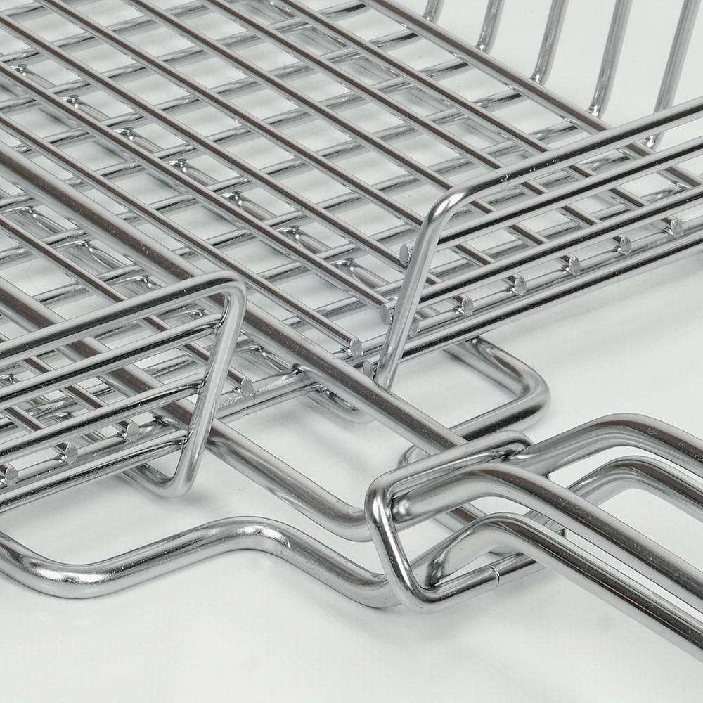 Close-up of a chrome metal grid. White background.