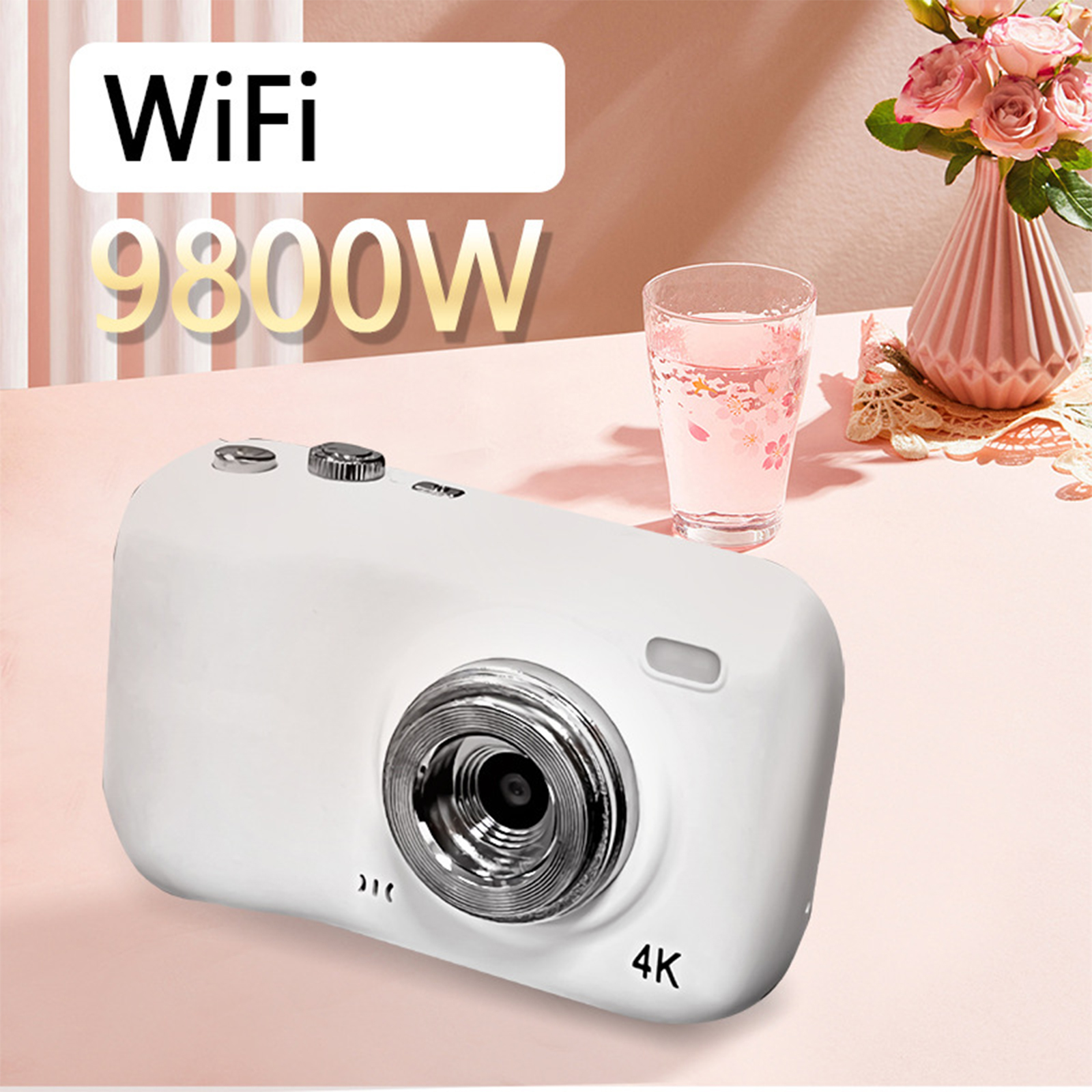 Weiße 4K-Kamera mit WiFi, ein Glas Wasser und eine rosa Vase auf rosa Oberfläche.