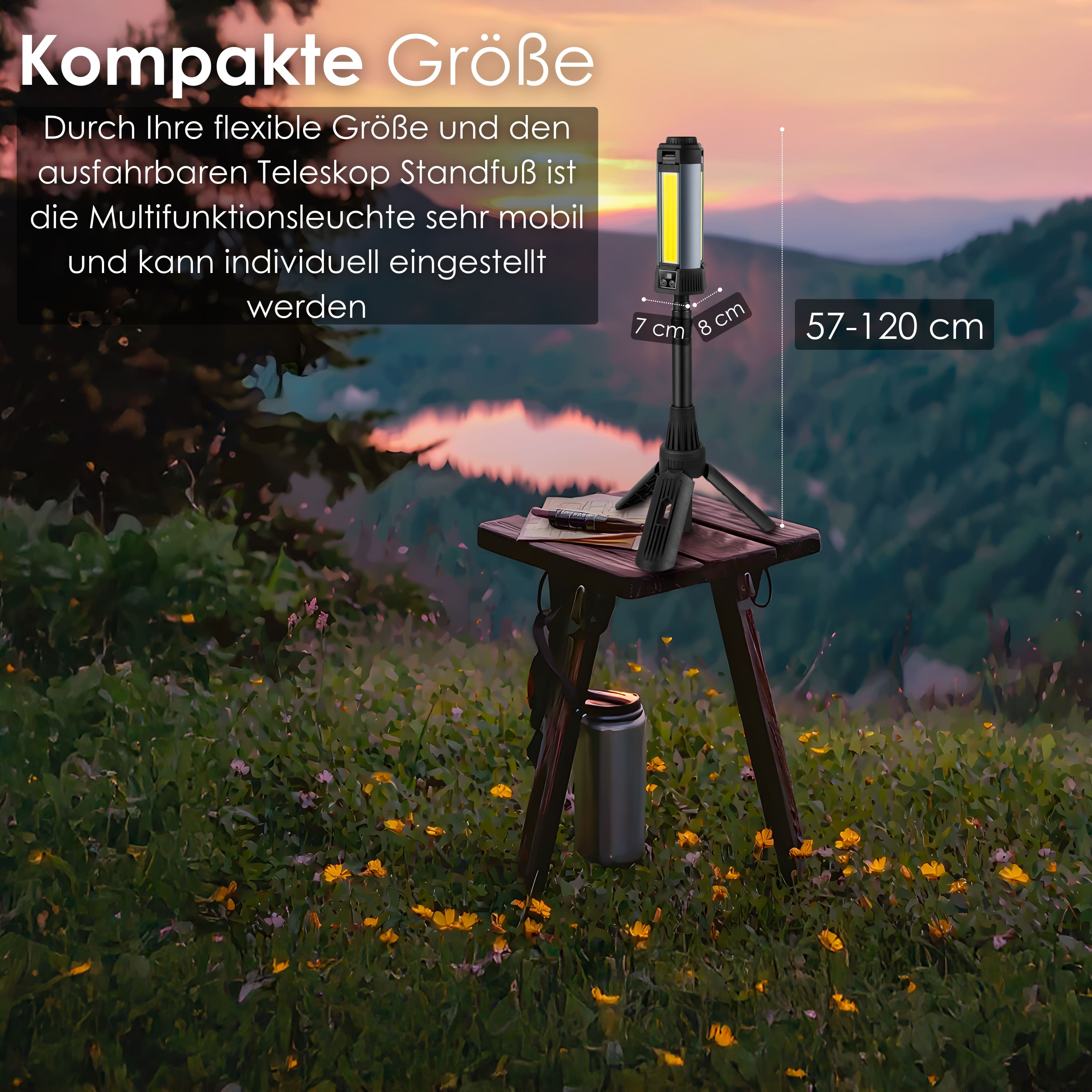 Schwarz-graue Lampe auf einem Stativ auf einem Tisch, in einem Feld mit Blumen und Bergen.