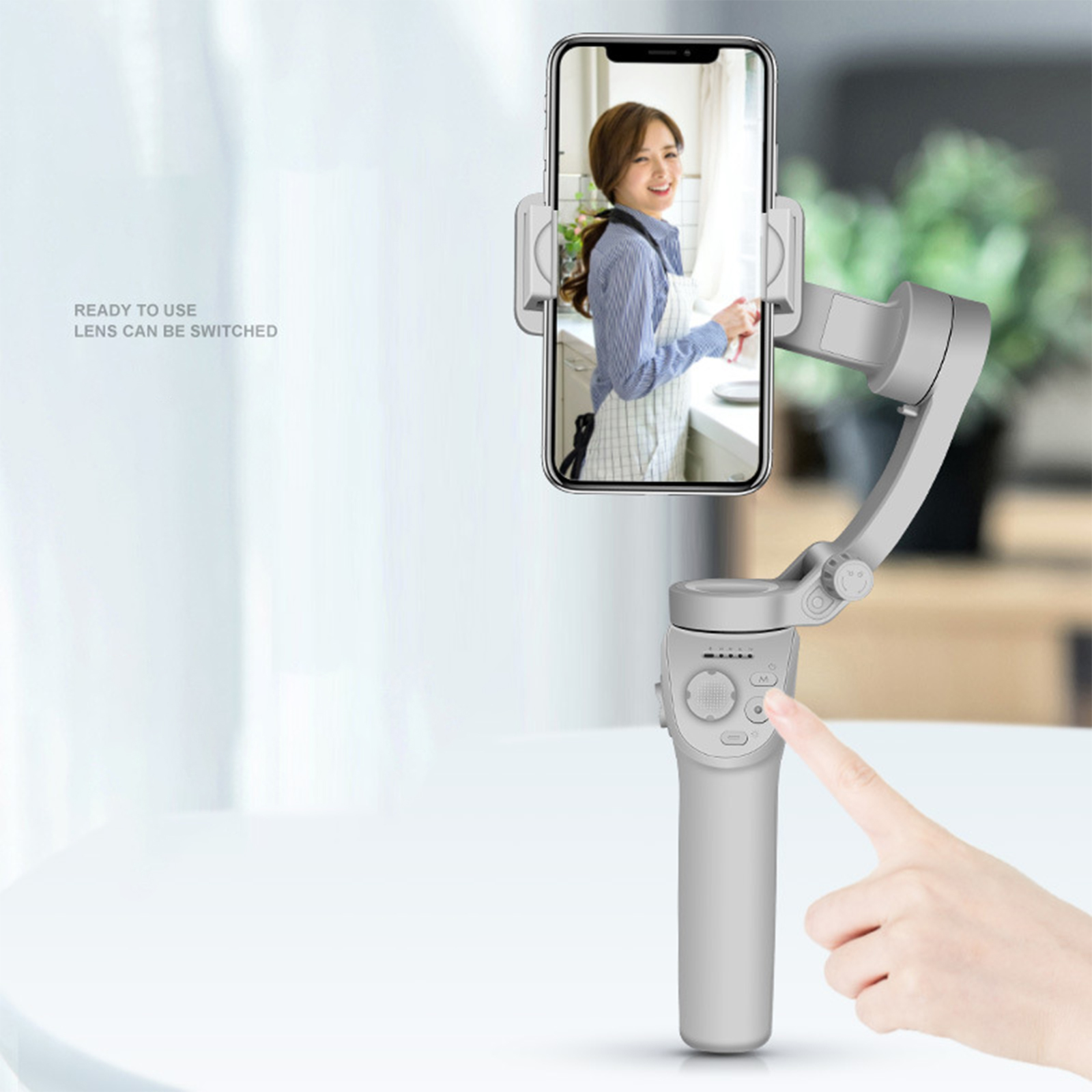 Hand hält Smartphone in Gimbal, zeigt Frau. Weiße Oberfläche, sofort einsatzbereit.