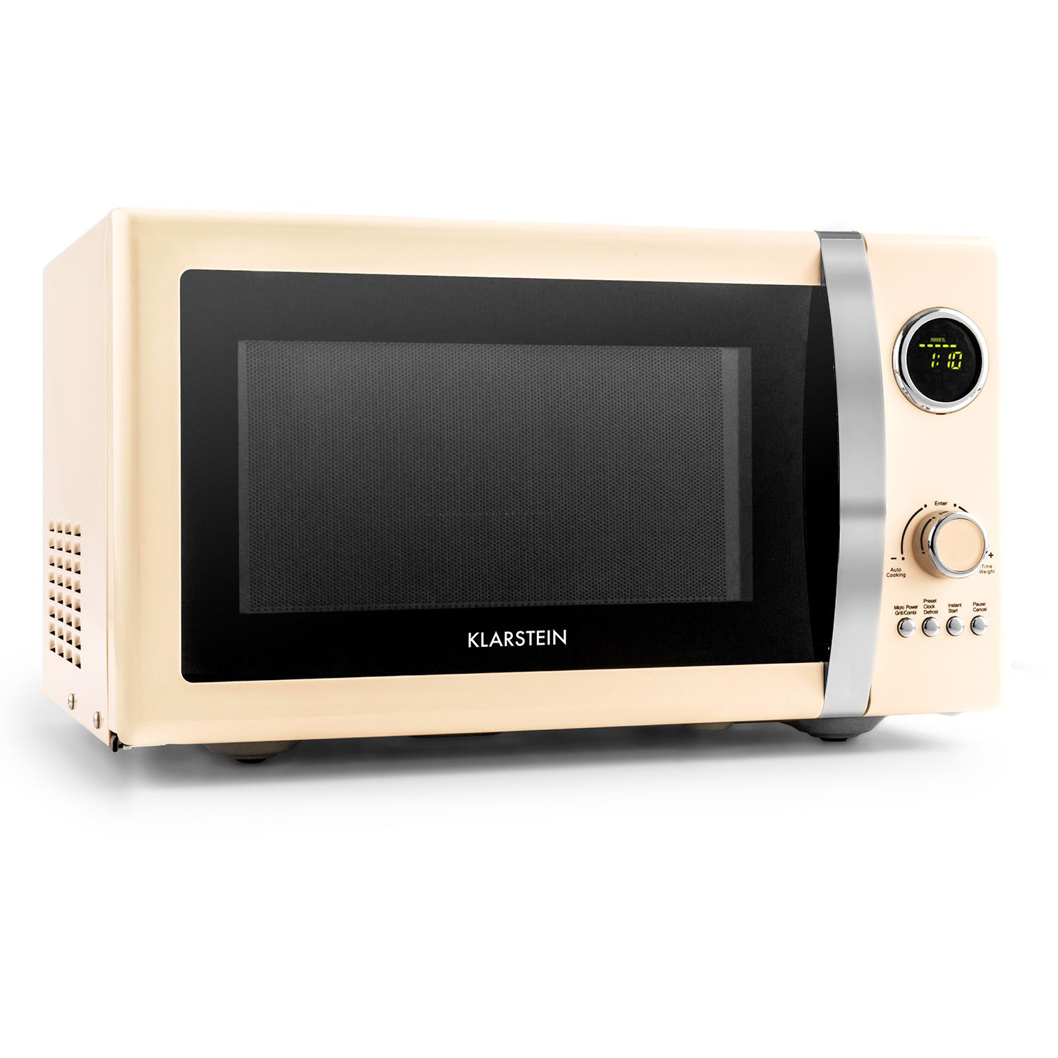 Microondas color crema. Tiene una puerta negra, asa y ribete plateados, y una pantalla digital.