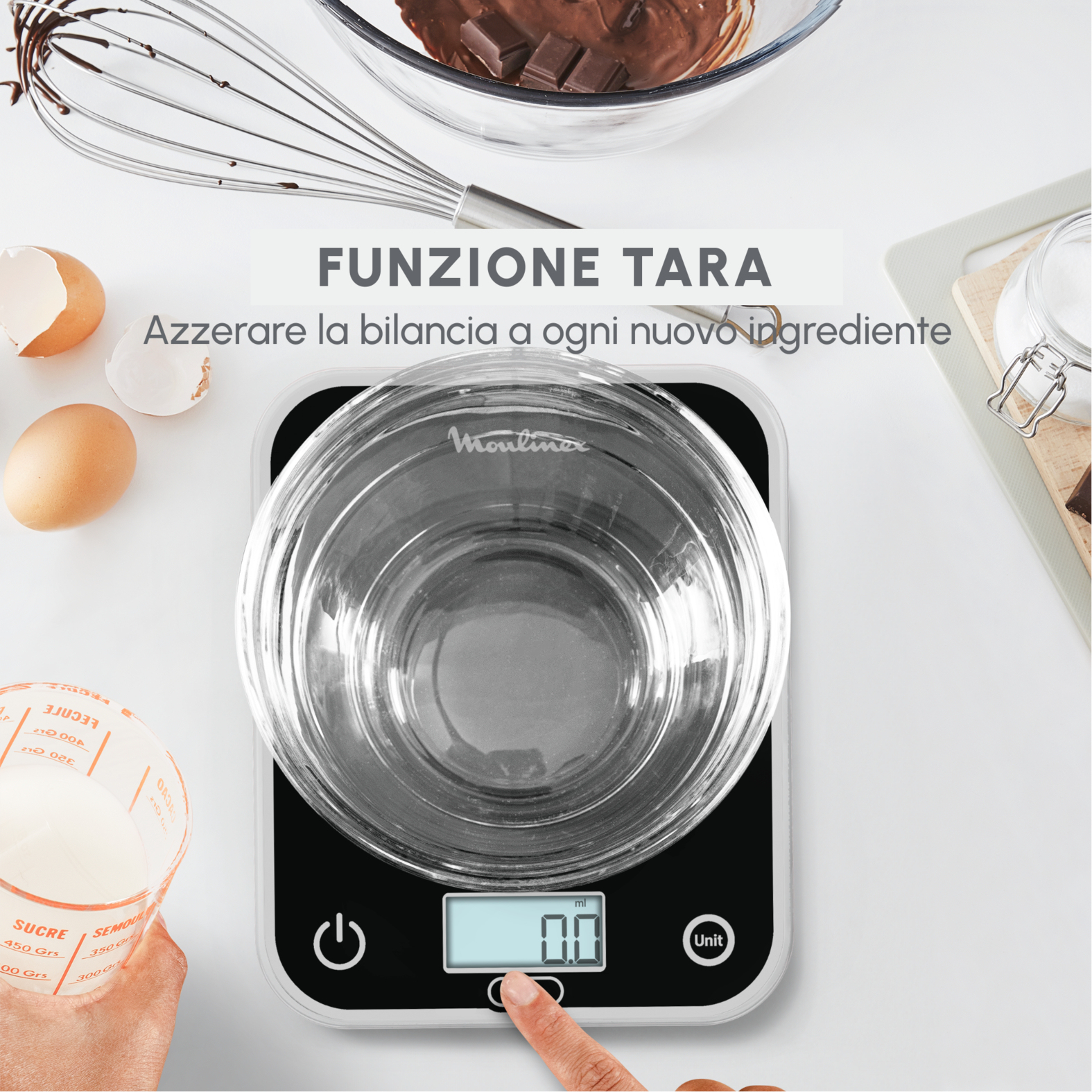 Osoba używająca wagi cyfrowej z miską. Składniki takie jak jajka wokół.