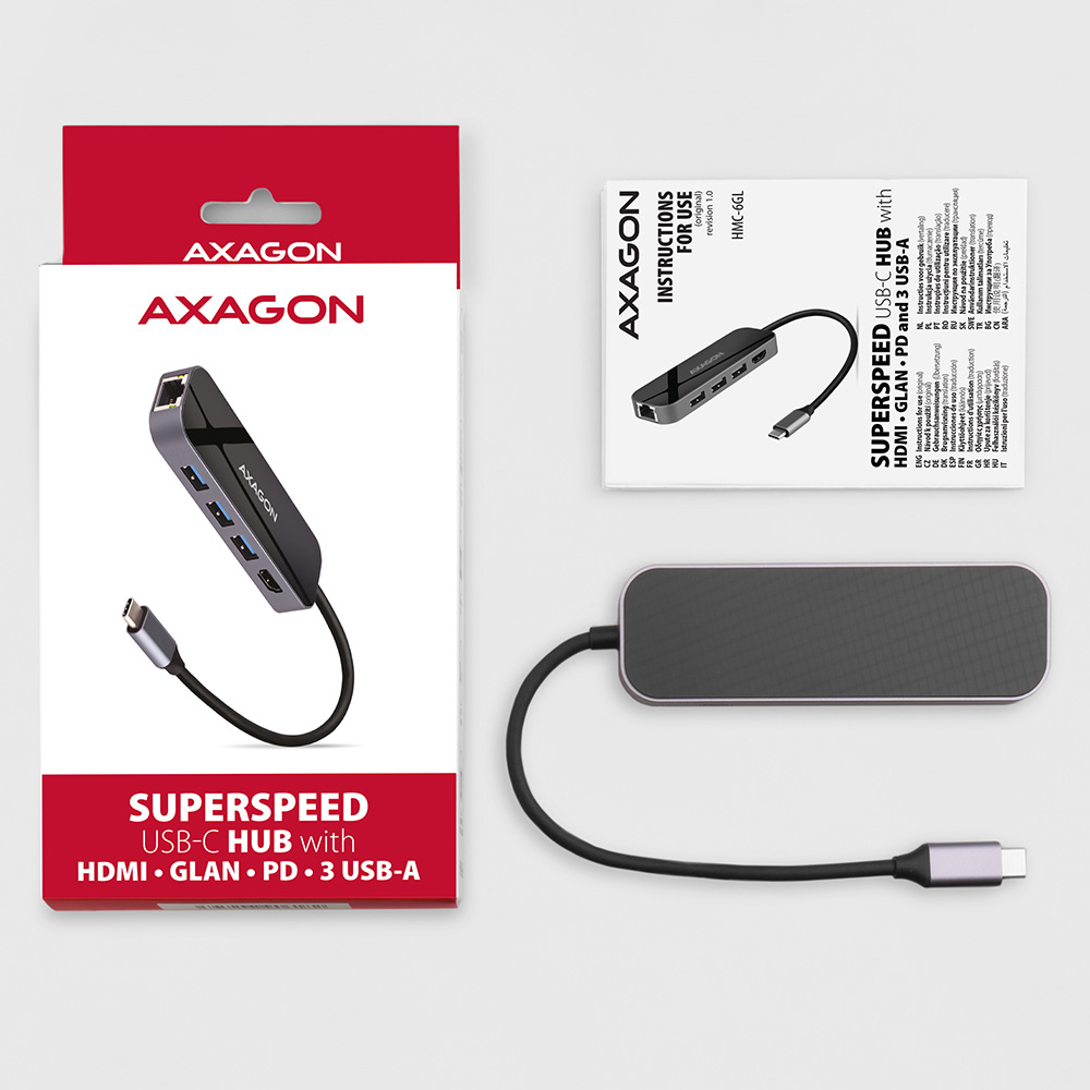 Ein schwarzer und grauer USB-Hub mit Box und Anleitung. Es hat mehrere Anschlüsse. Ein schwarzes Kabel ist angeschlossen.