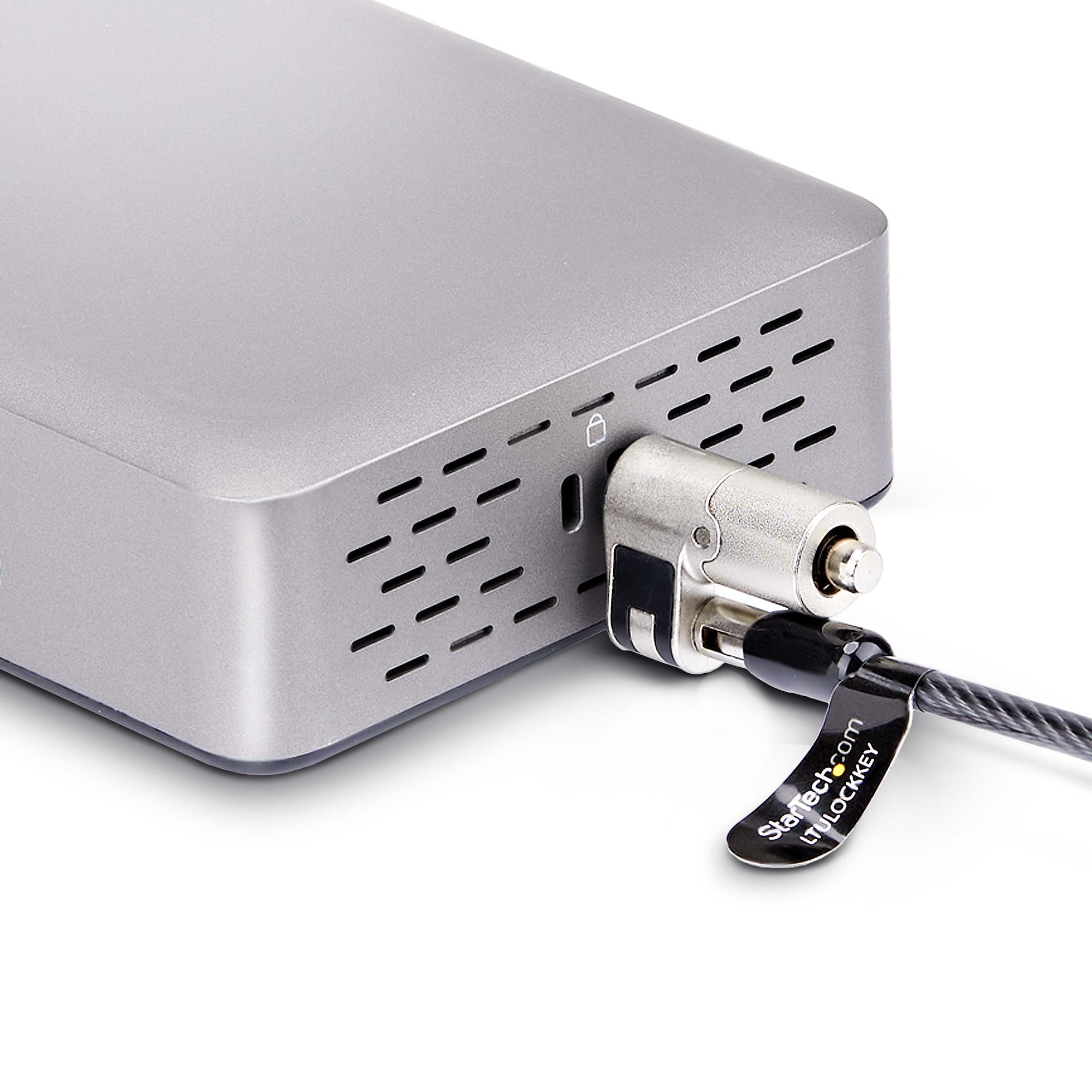 Un disque dur externe argenté sécurisé par un verrou à câble. Le verrou est attaché au disque dur.