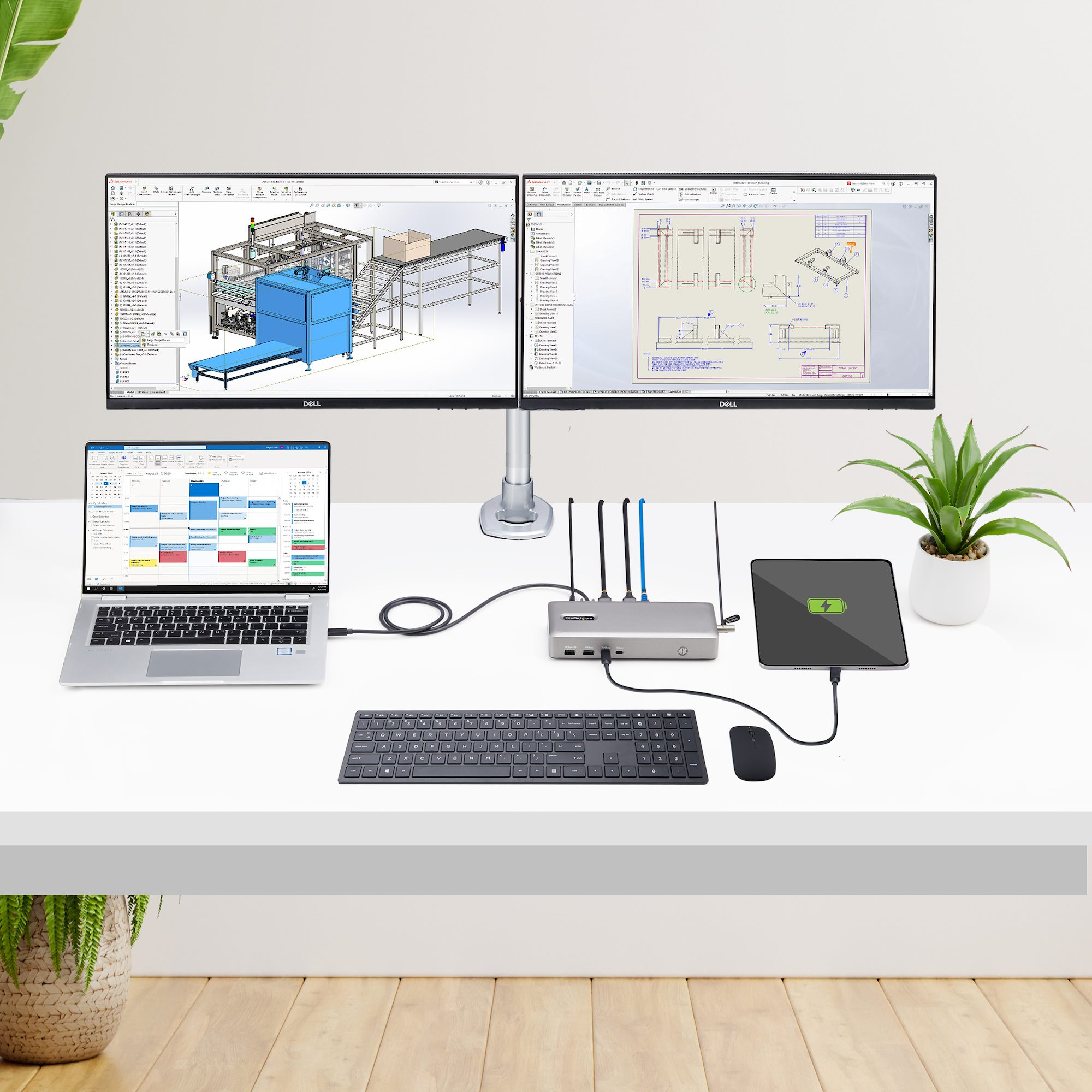 Espace de travail : deux moniteurs, ordinateur portable, clavier, souris et plante. Affiche les outils d'ingénierie et de conception.