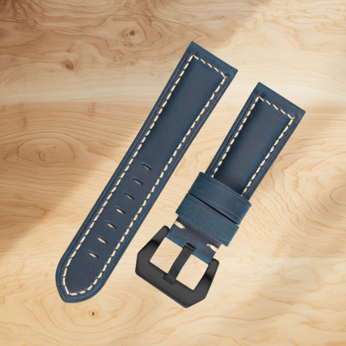 Due cinturini blu in pelle con cuciture bianche e fibbia nera.