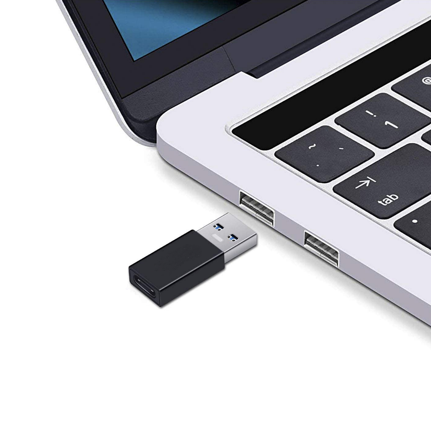 Un adattatore da USB-C a USB collegato a un laptop. L'adattatore è nero e il laptop è argentato.