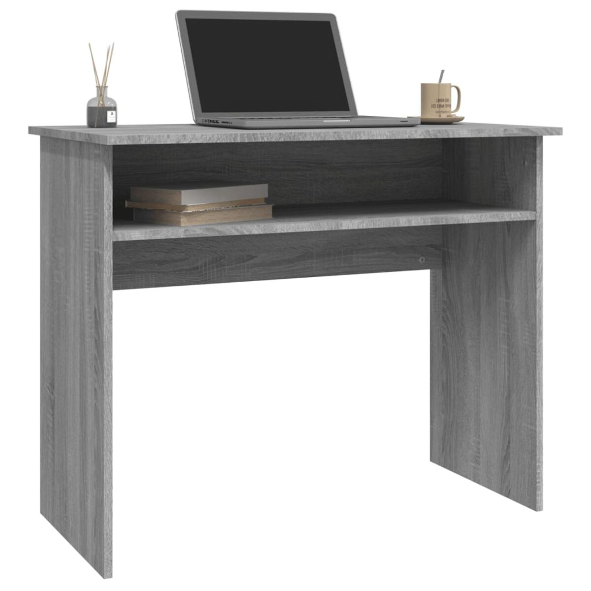 Ein grauer Schreibtisch hat einen Laptop, Bücher und eine Tasse mit Untersetzer. Es gibt auch einen Diffusor.