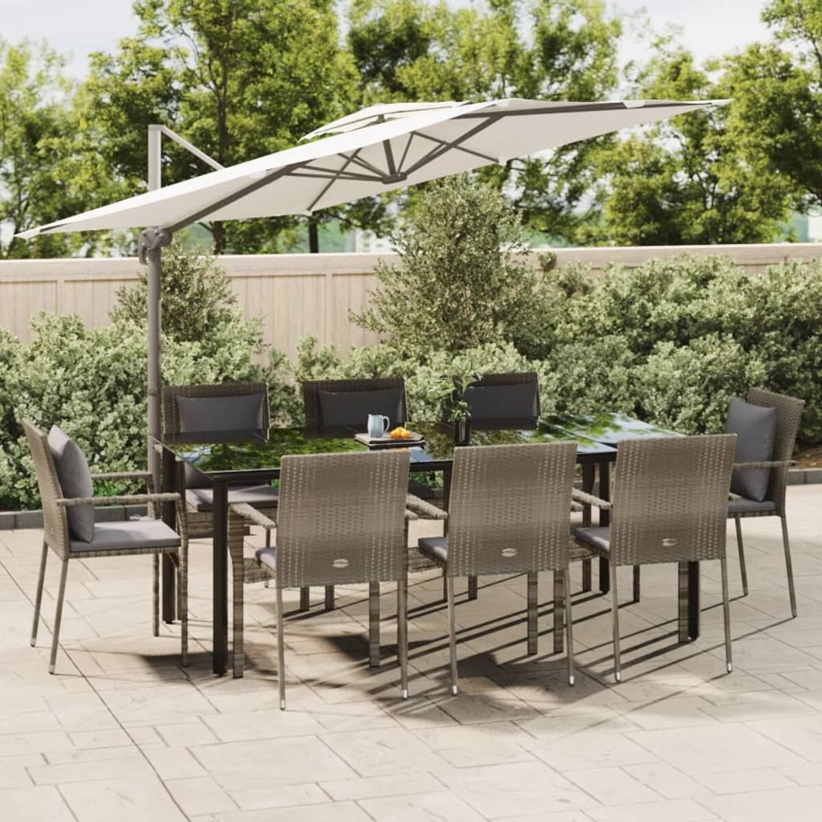 Ein Esszimmer-Set im Freien mit einem rechteckigen Tisch, Stühlen und großem Schirm.