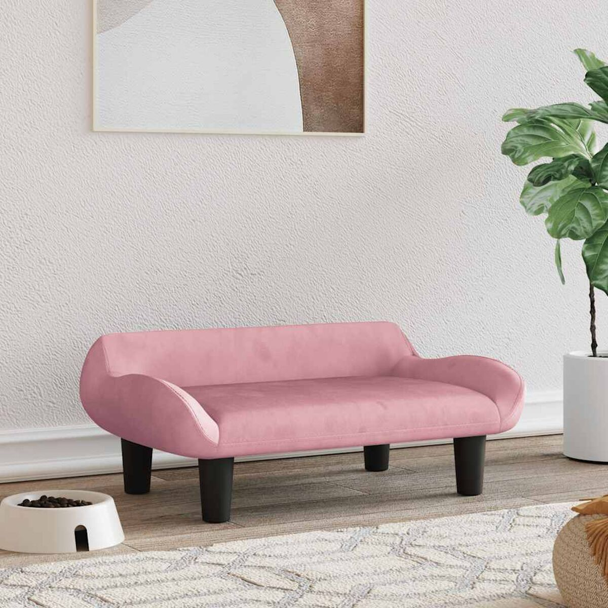 Rosa Sofa für ein Haustier, mit schwarzen Beinen und einer weißen Schüssel auf dem Boden.