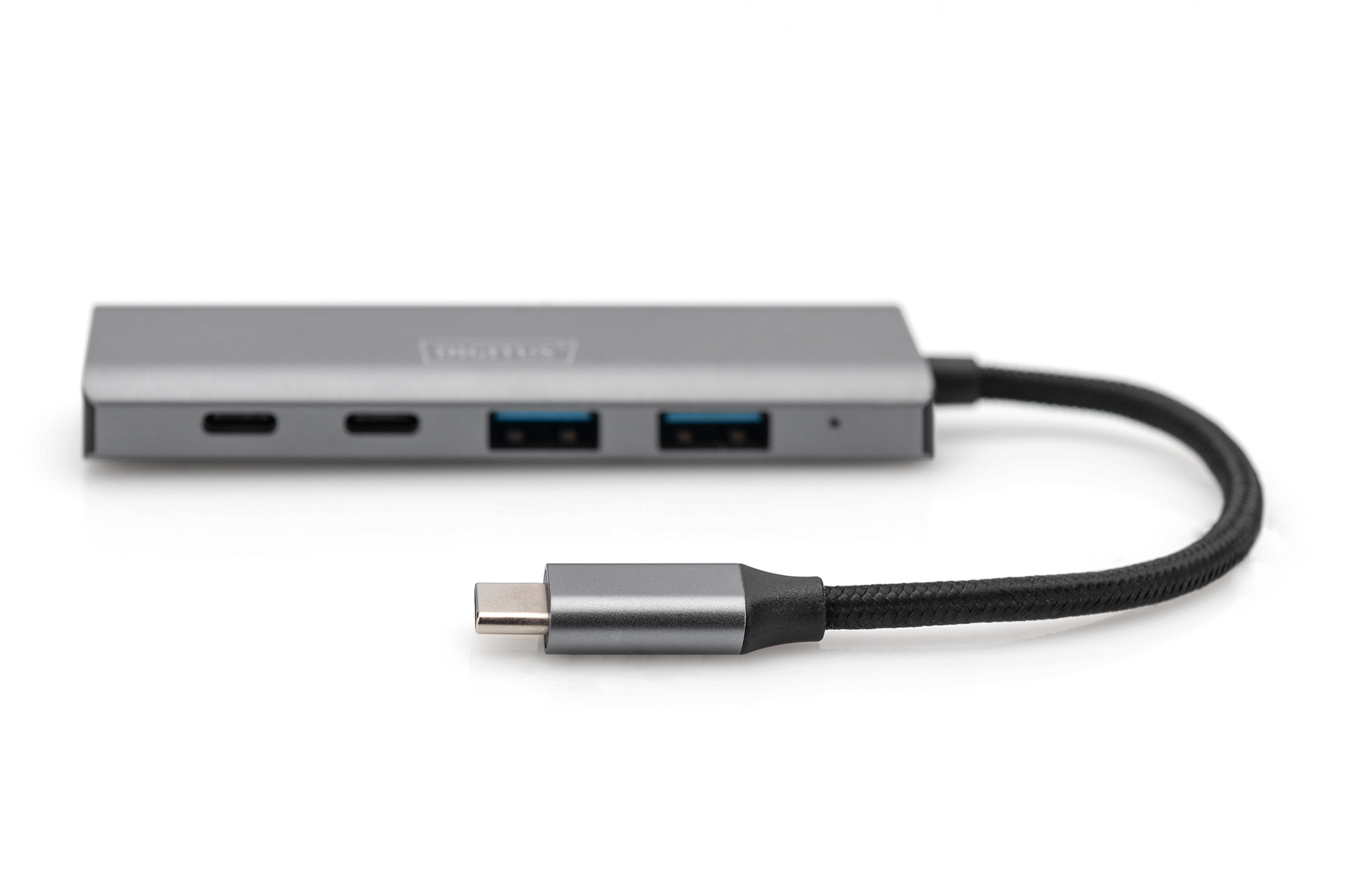 Un hub USB-C argentato con cavo nero e connettore USB-C su una superficie bianca.
