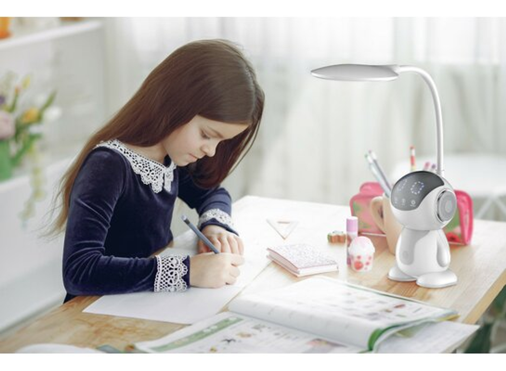 Una ragazza scrive a una scrivania. C'è una lampada da scrivania e una borsa rosa.