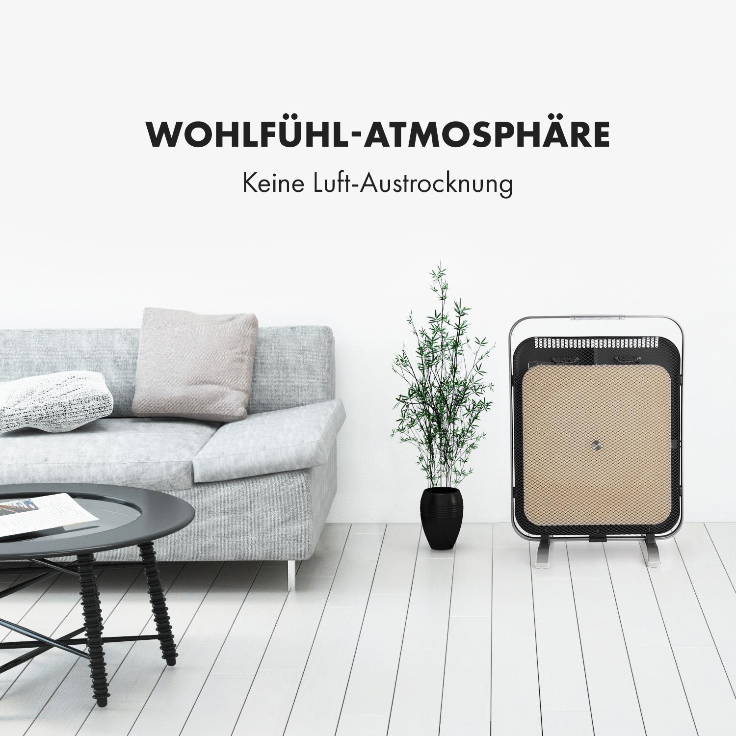 Wohnzimmer mit grauem Sofa, schwarzem Tisch, Pflanze und Heizung mit Text darüber.