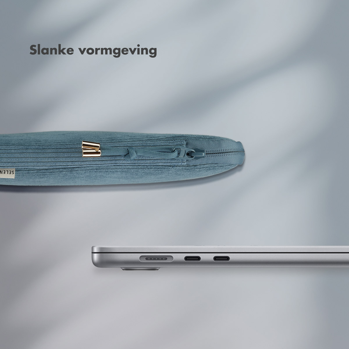 A teal-colored laptop sleeve with a zipper, next to a silver laptop.