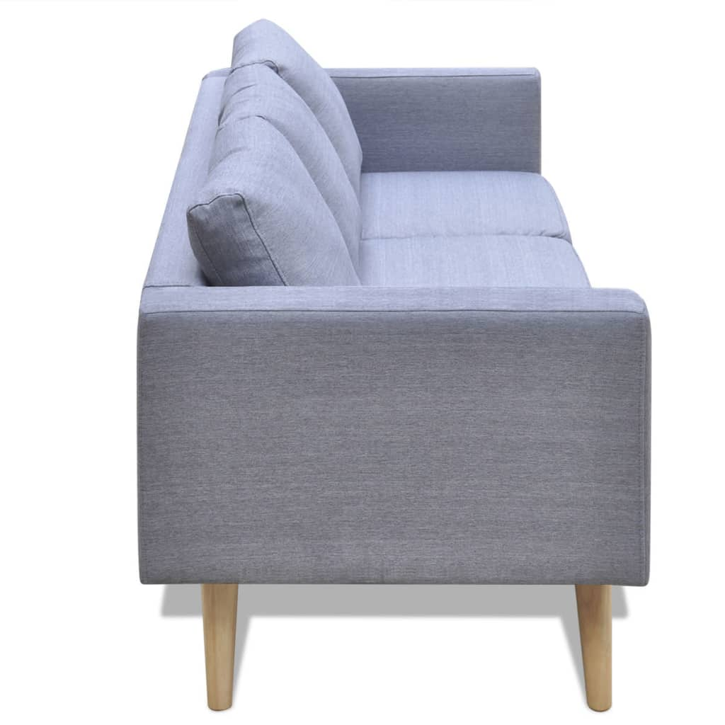Seitenansicht eines grauen Stoffsofas mit Holzbeinen, auf weißer Oberfläche stehend.