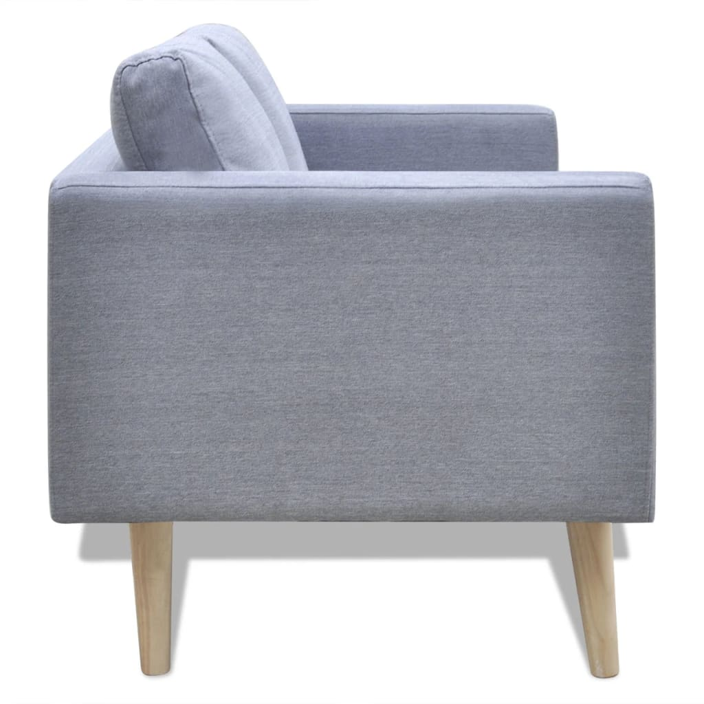 Seitenansicht eines grauen Sofas mit hellen Holzbeinen. Zeigt die Armlehne, das Kissen und die Rückenlehne.