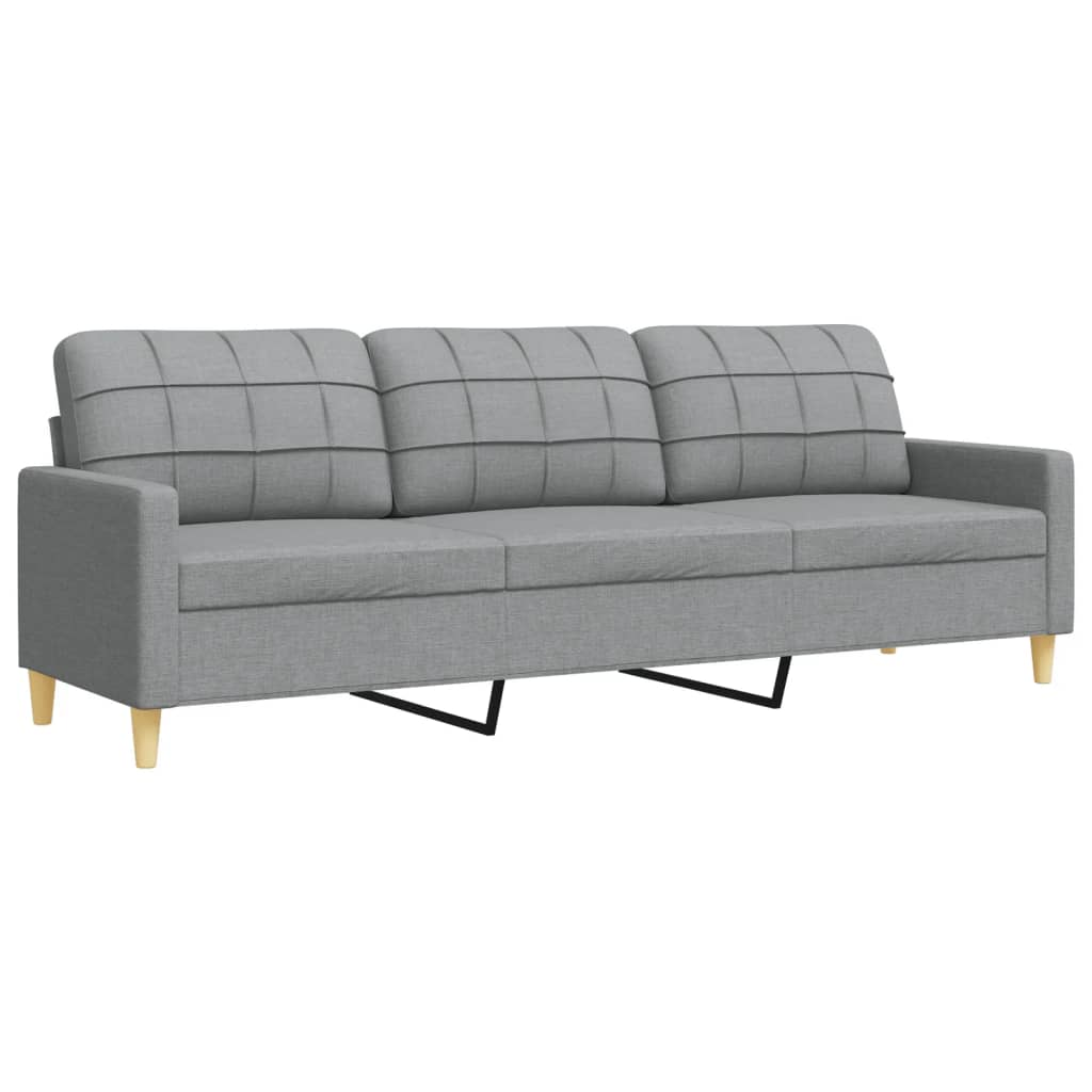 Graues Stoffsofa mit drei Kissen und Holzbeinen.