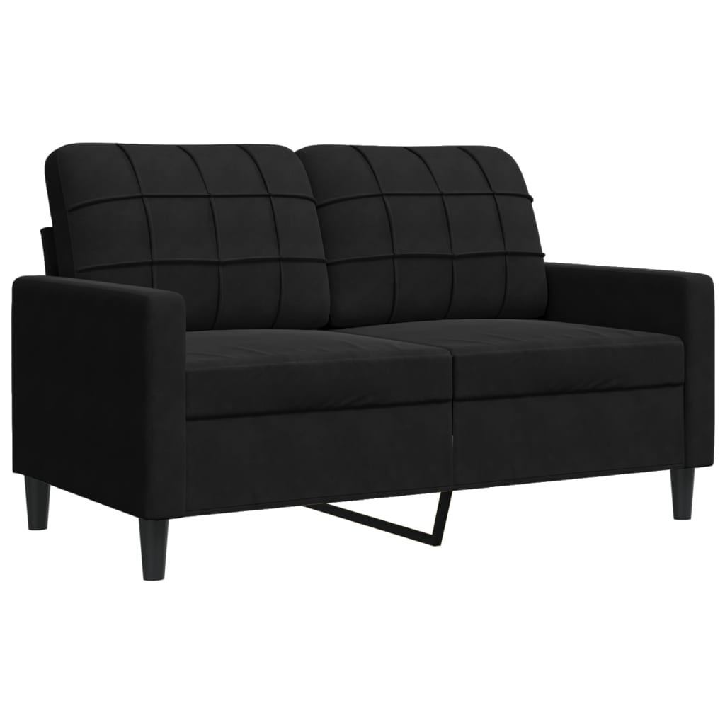 Ein schwarzes Sofa mit einem quadratischen Muster auf dem Rücken und den Armlehnen.