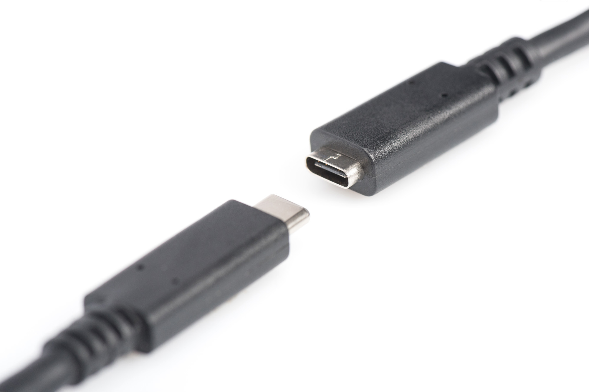 Two black USB-C cables, one disconnected, on a white background.