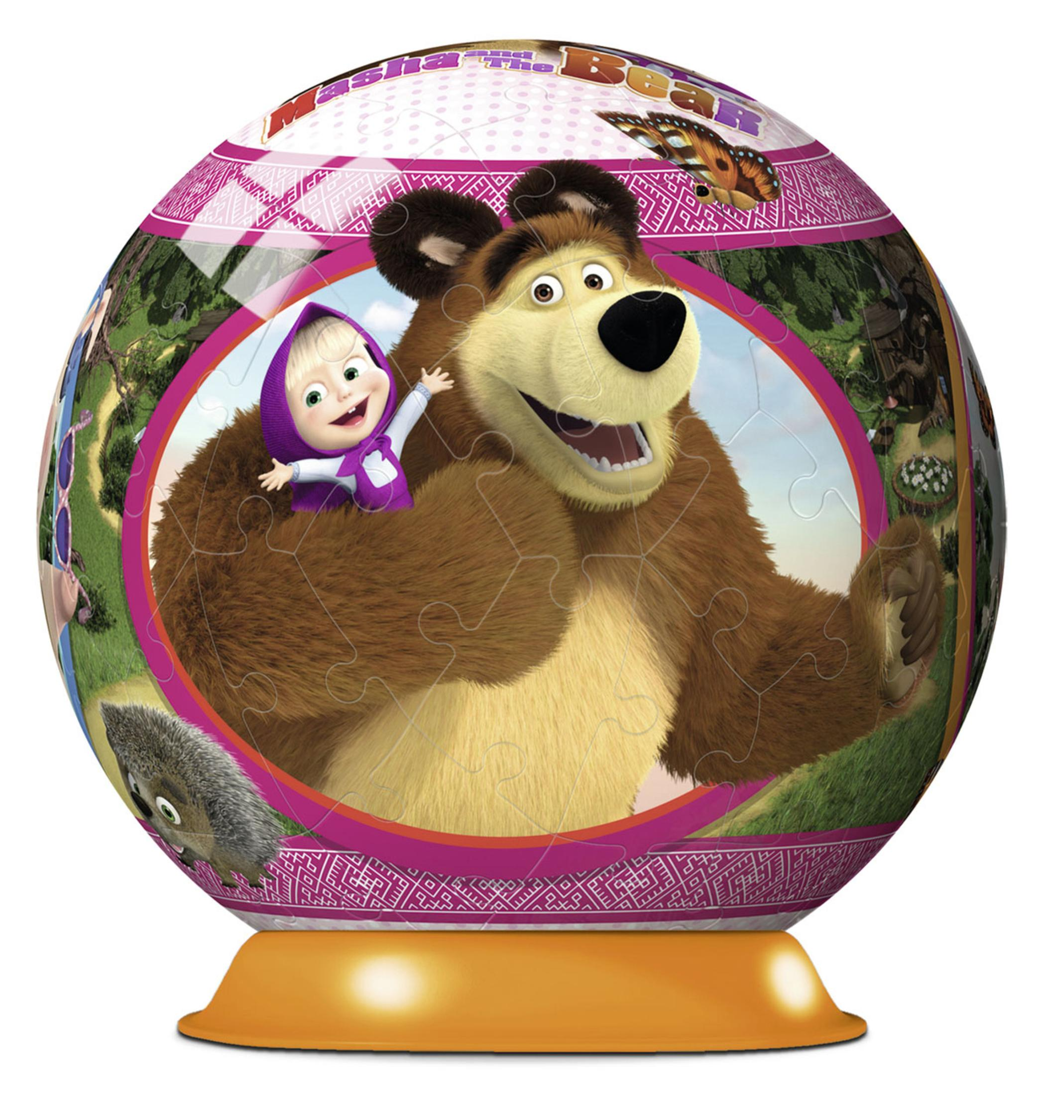 Sferyczna układanka z kreskówkowym obrazkiem Maszy i Niedźwiedzia. Stoi na pomarańczowej podstawie.