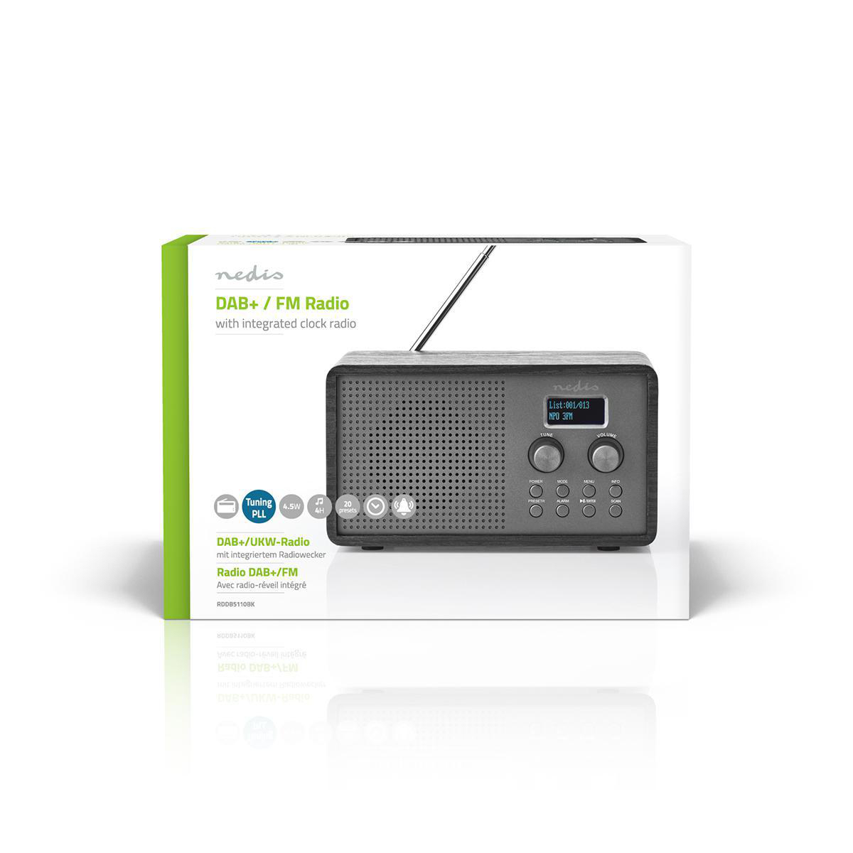 Radio en una caja. La caja es blanca y verde, y la radio es negra con una pantalla.