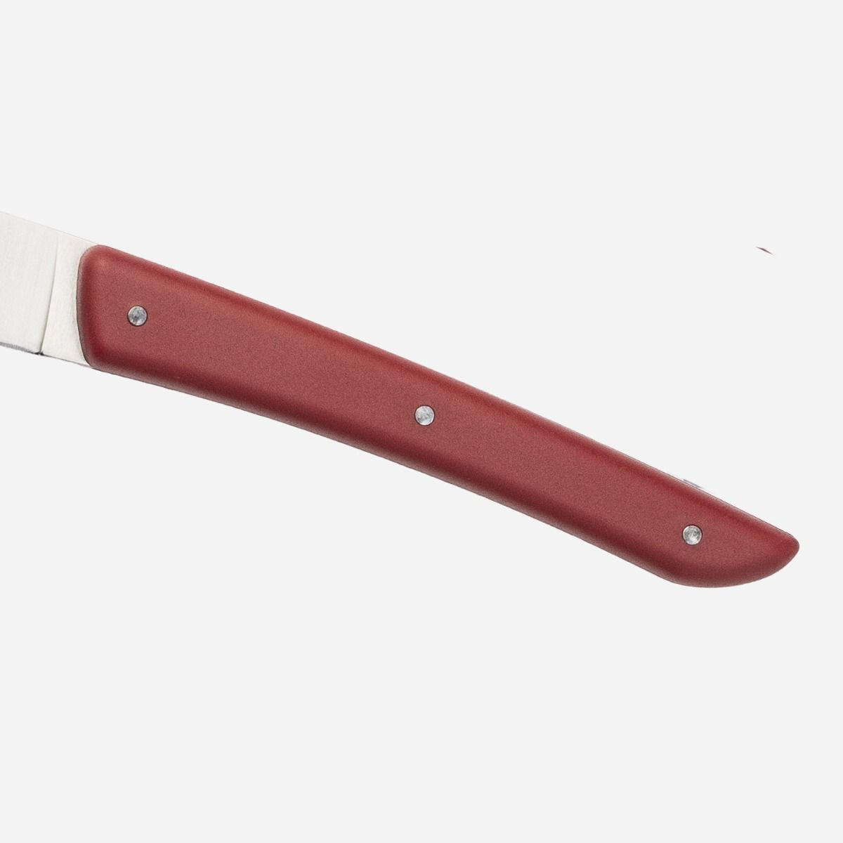 Knife handle, red with silver rivets. Blade partially visible, white background.