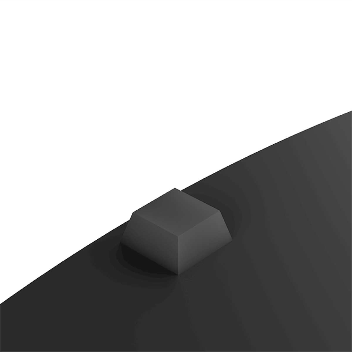 A gray, angular object on a black surface. The object is in the center, angled to the right.