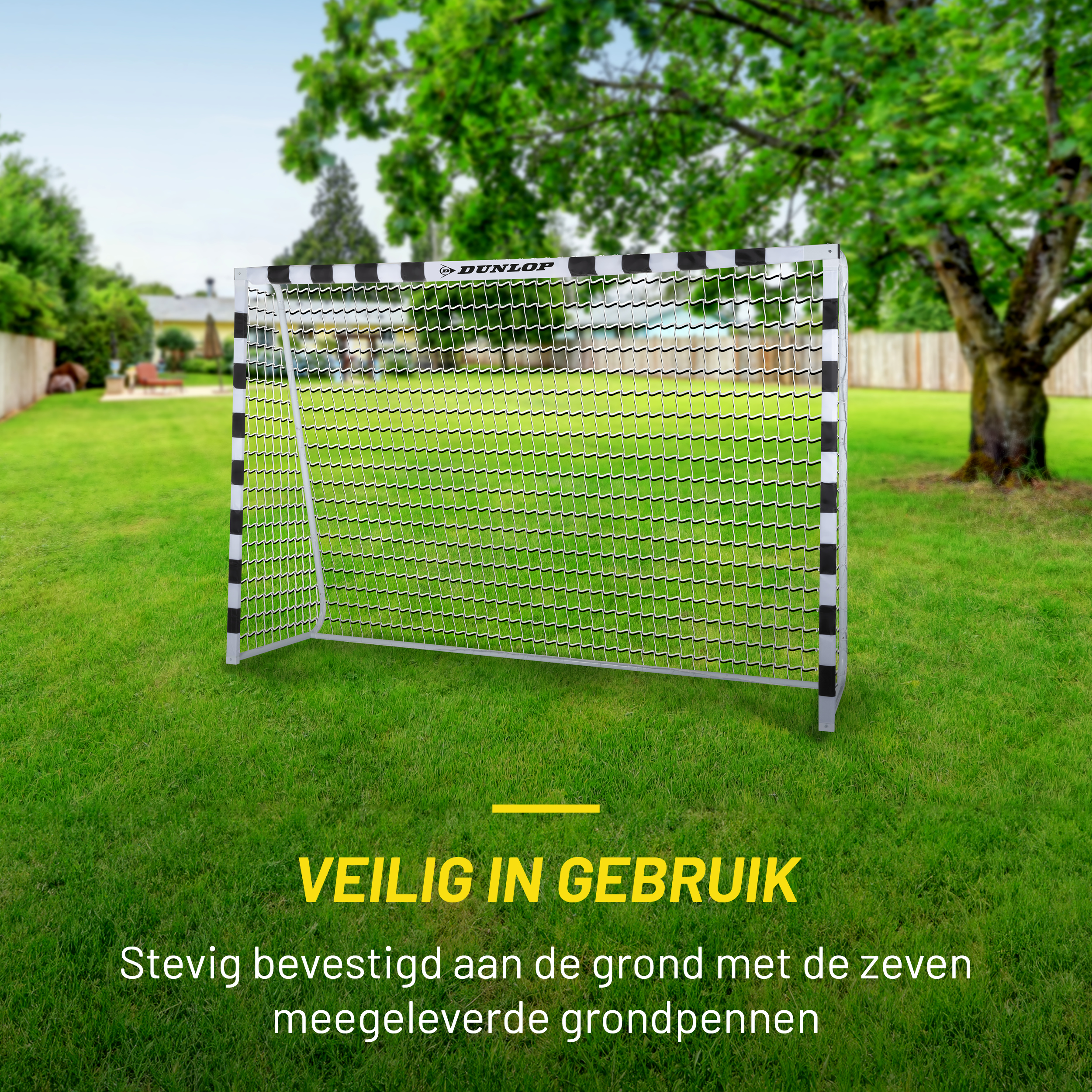 Voetbaldoel op groen gazon. Bomen op de achtergrond. Tekst: 'veilig in gebruik' en 'stevig met zeven pinnen bevestigd'.