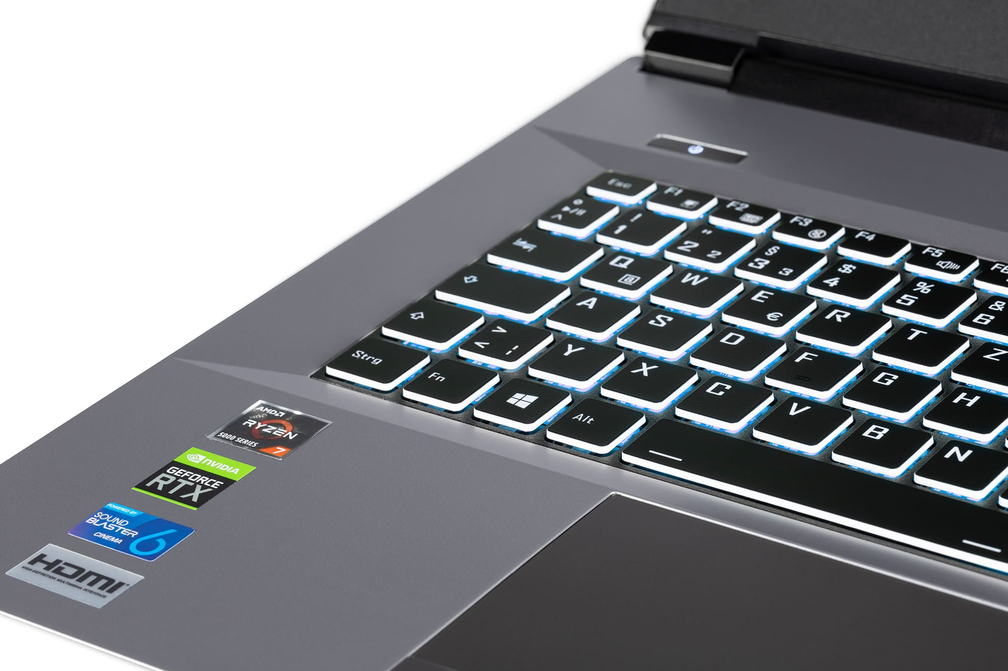 Primo piano della tastiera di un laptop da gioco con tasti illuminati, che mostra adesivi.