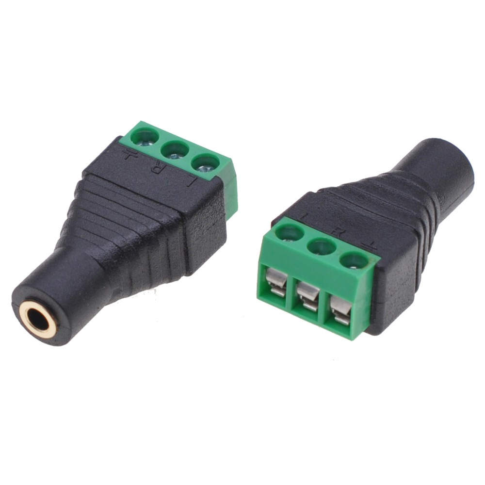 Due connettori audio neri, terminali verdi, sfondo bianco.