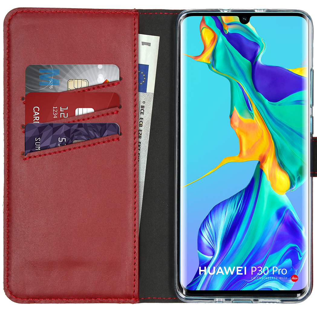 Red leather phone case open, cards and money visible. Phone inside, screen on.