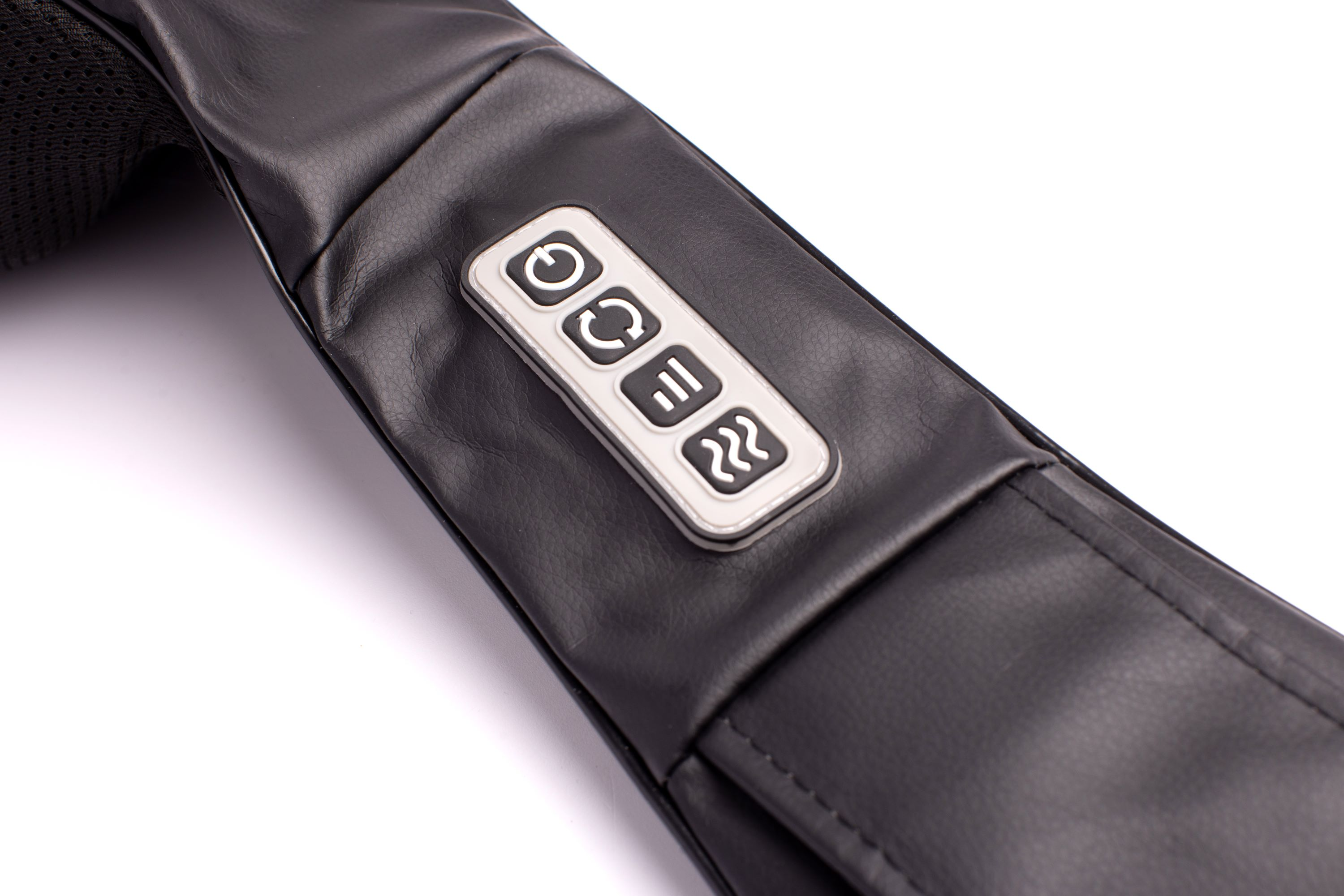 Black massage device with buttons for power, modes, and heat. Close-up view.