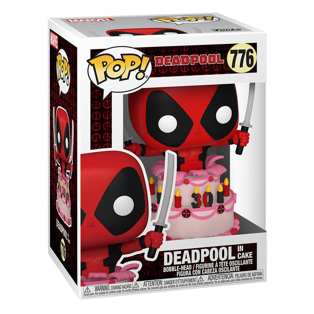 Figurka Deadpoola trzymająca miecze na torcie. Jest w pudełku z logo Pop! i Deadpoolem.