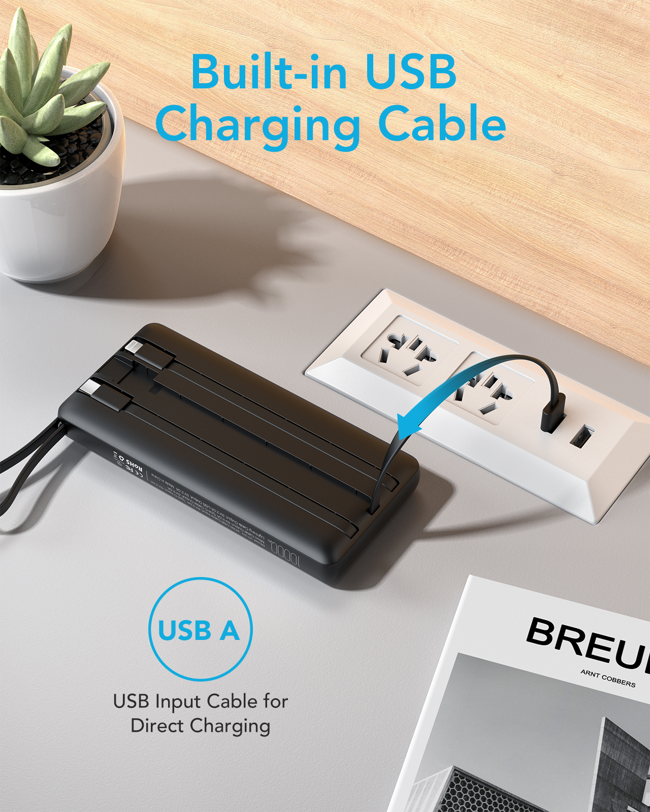 Schwarze Powerbank mit USB-Kabel an Steckdose, Zeitschrift daneben.