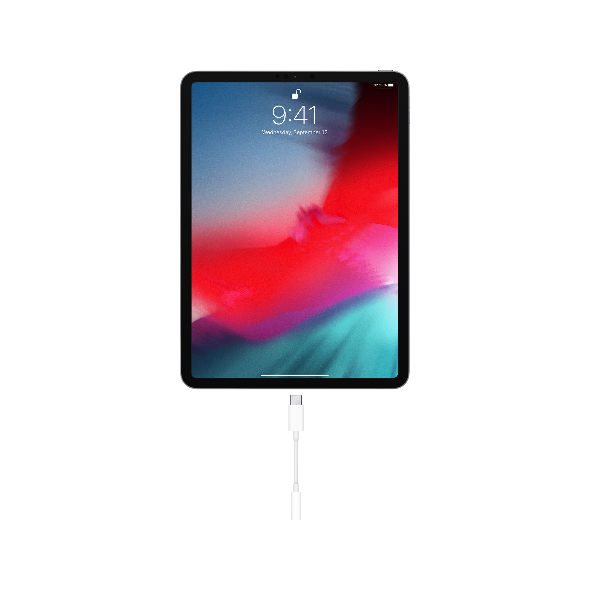 iPad con cavo bianco collegato. Lo schermo mostra l'ora e la data.