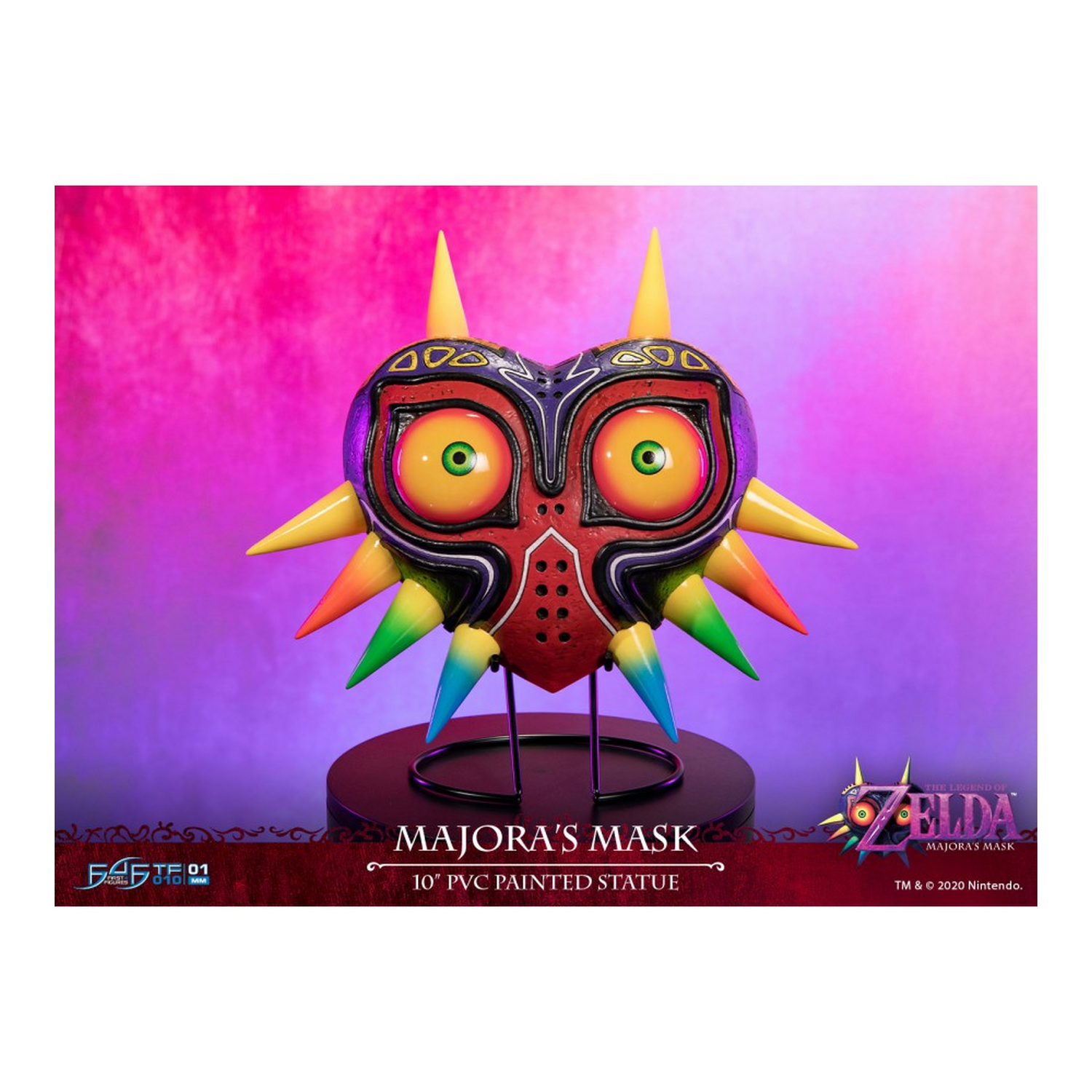 Majora's Mask auf einem Ständer mit einem Hintergrund einer verschwommenen bunten Szene. Produktdetails.
