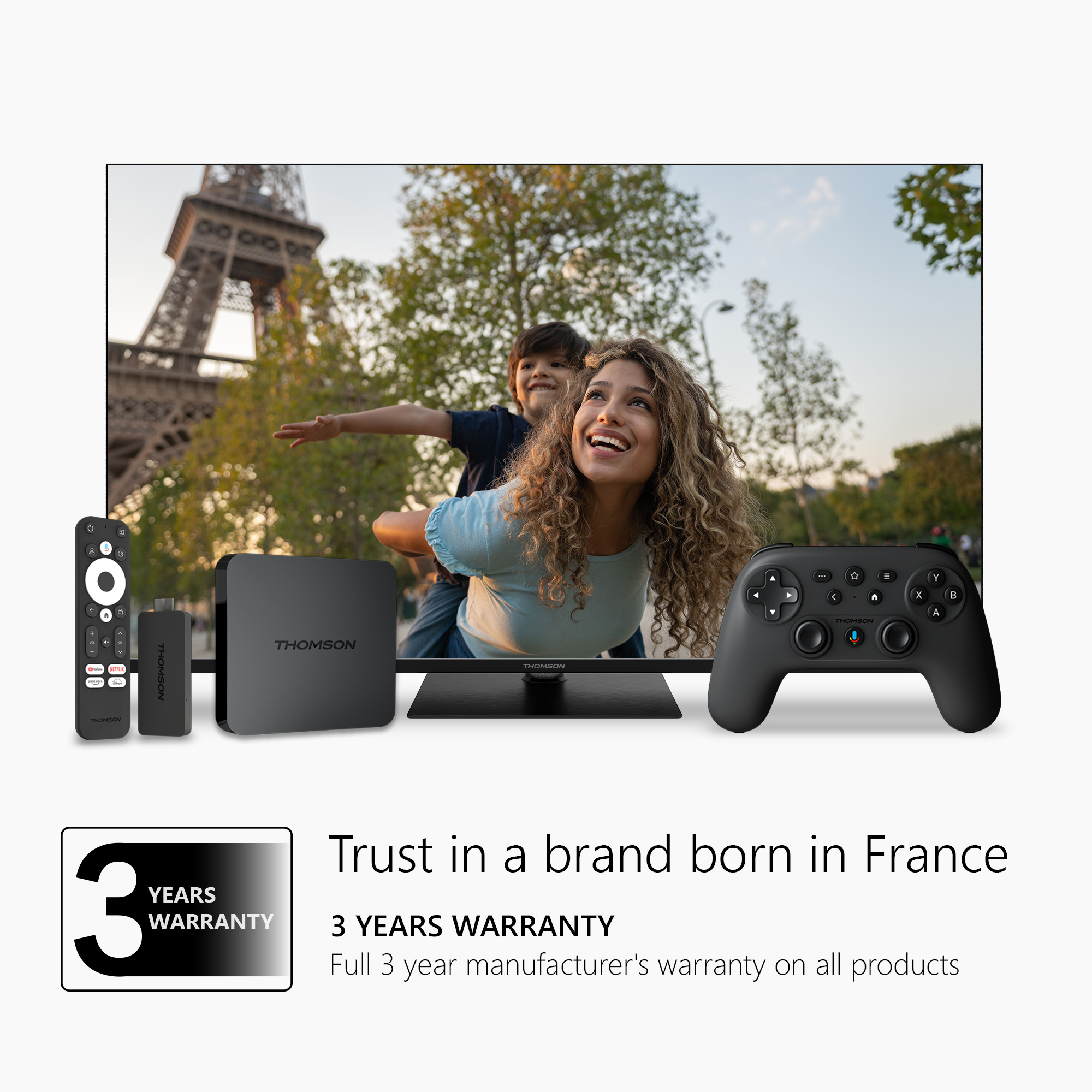 A family enjoying a TV. Includes a remote, a streaming device, and a game controller.