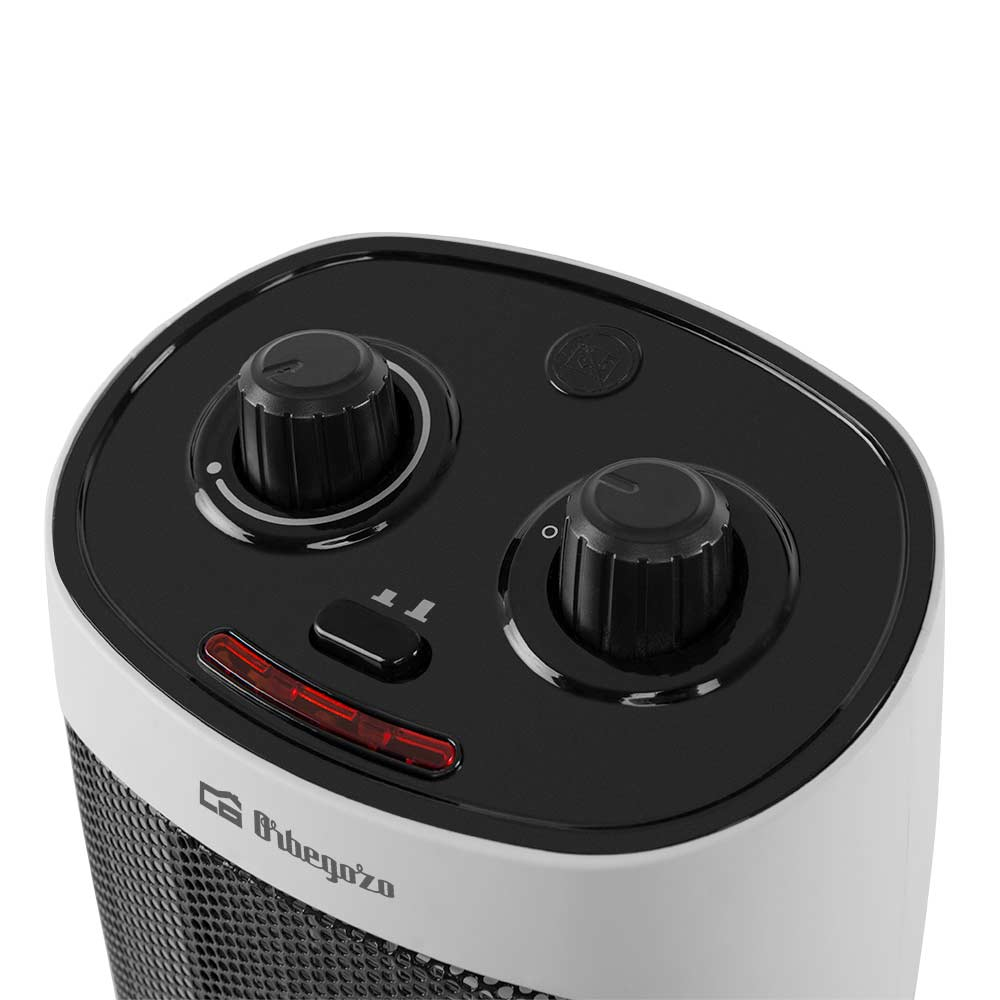 Zbliżenie czarno-białego panelu sterowania grzejnikiem. Widoczne są dwa pokrętła i czerwone światło.