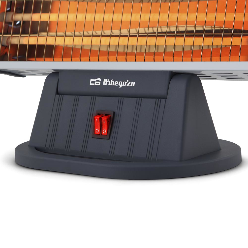 Primer plano de la base de un calefactor eléctrico con interruptores de encendido/apagado rojos.