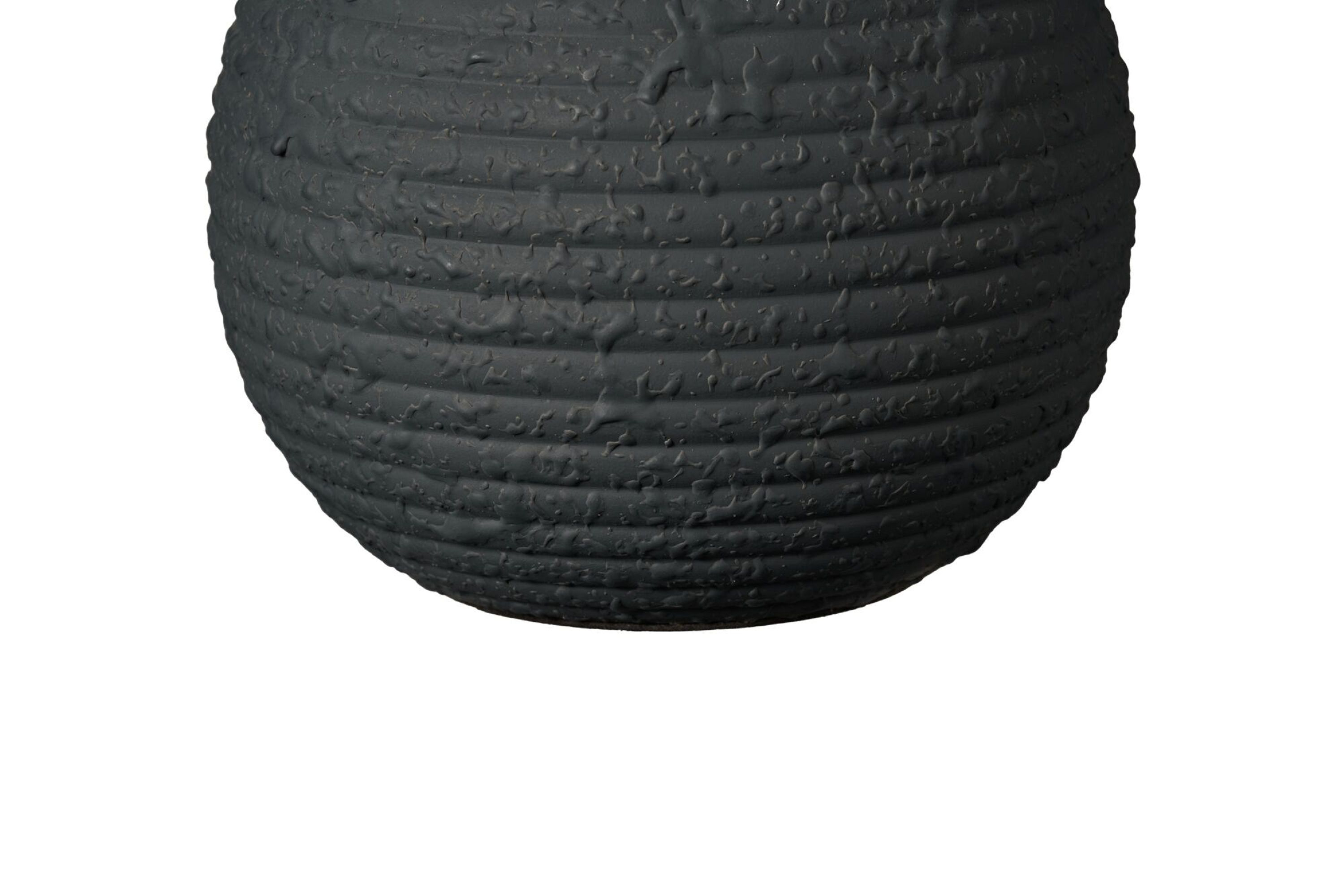 Biały cylindryczny wazon z wieloma małymi otworami wokół korpusu.