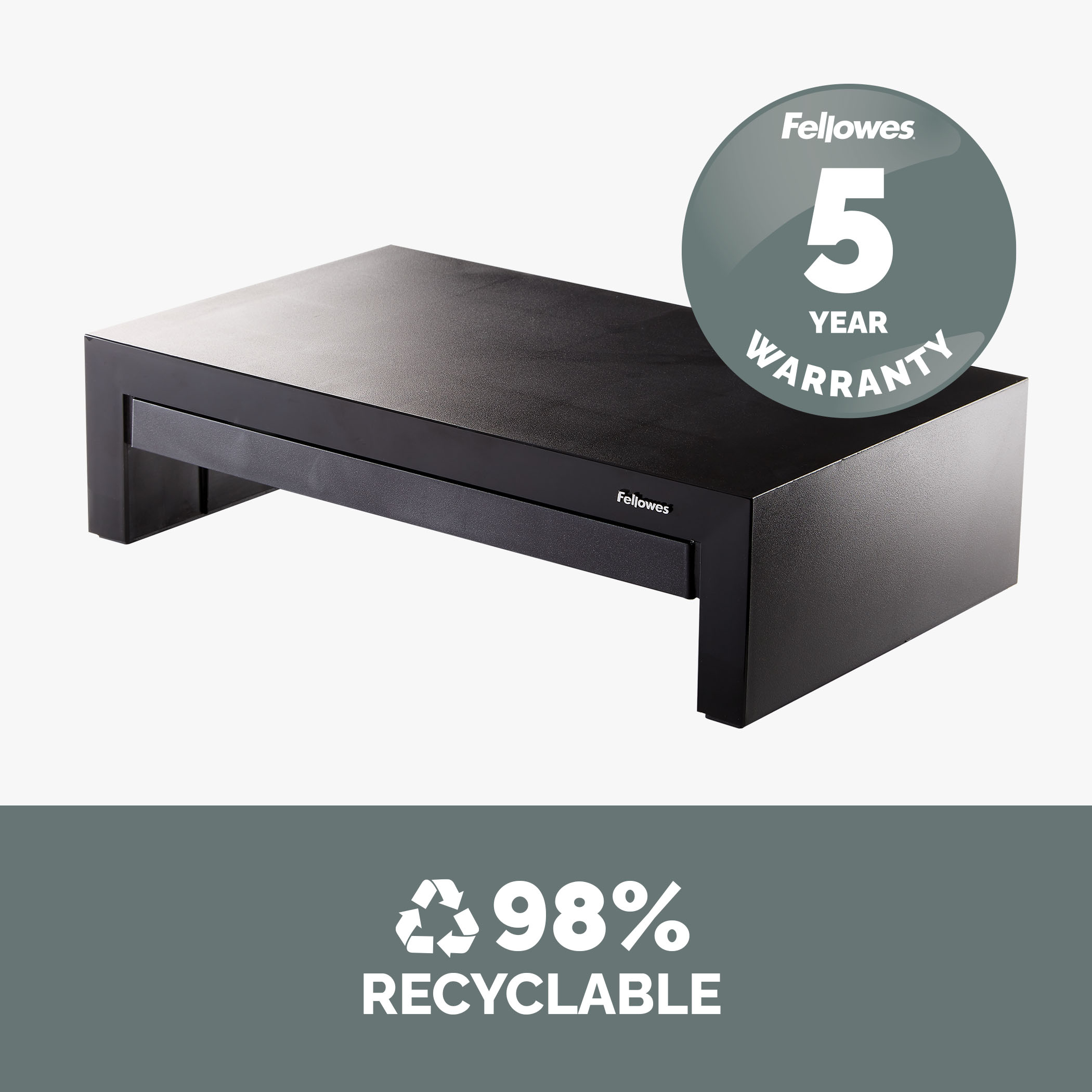 Czarny stojak na monitor z szufladą, widoczne słowa '5 LAT GWARANCJI' i '98% DO RECYKLINGU'.