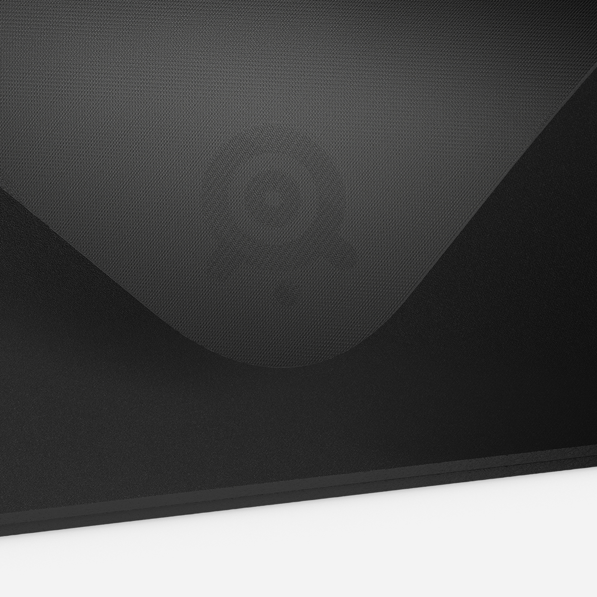 Black surface with a textured pattern and a logo in the center.