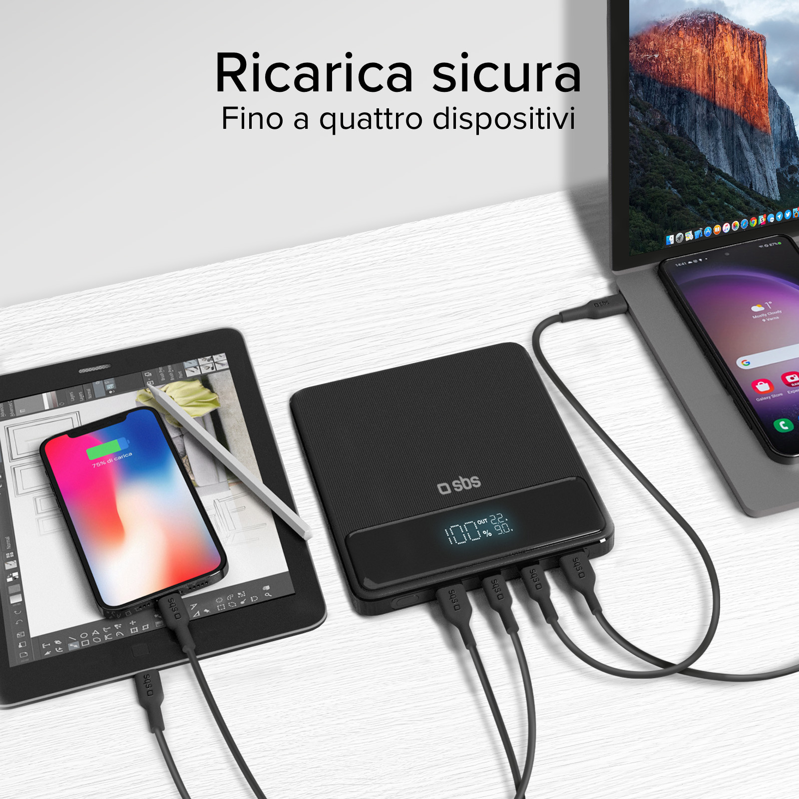 Power bank nero che carica iPad, telefono e laptop. I display mostrano le percentuali di carica.
