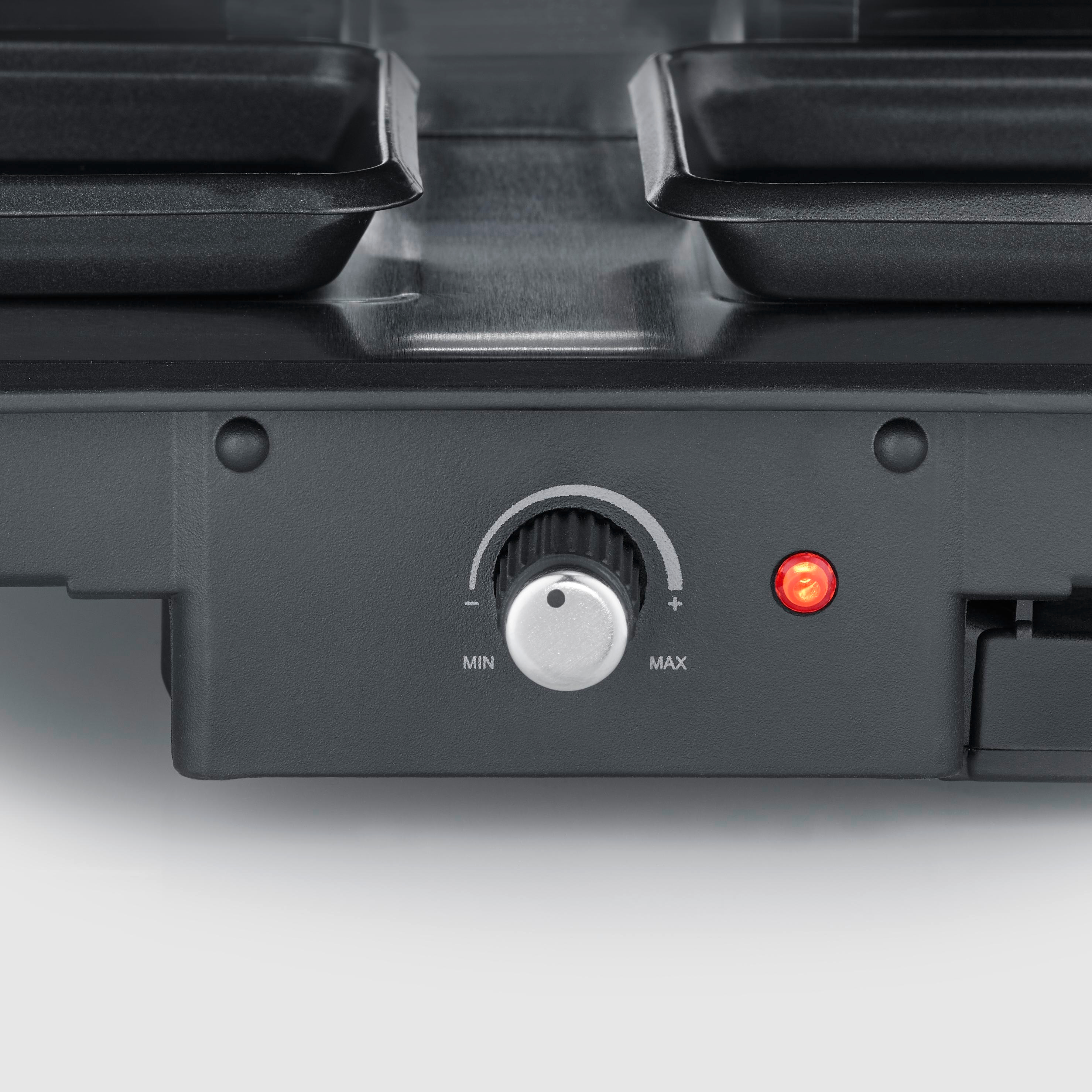 Zbliżenie panelu sterowania do raclette: pokrętło, kontrolka i dwie tace.