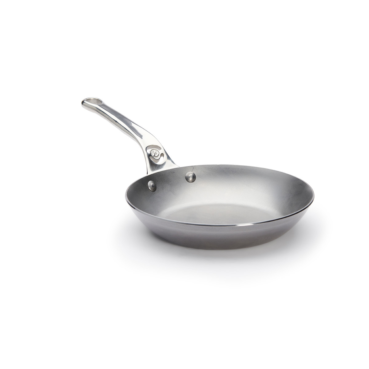 Stainless steel pan with a handle. It sits on a white surface.